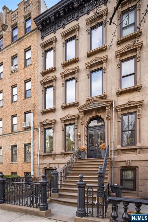 A rare and architecturally significant brownstone on one of Hobokenâ€™s most coveted blocks, 926 Hudson Street is a fully realized design residenceâ€”where historic craftsmanship and modern architecture are brought into deliberate and striking balance. Renovated and expanded by French interior designer Isabelle Péribère and featured in The New York Times, the home stands apart not only for its scale, but for the clarity and confidence of its design vision. Spanning approximately 5,000 square feet on an oversized 21.25â€™ x 110â€™ lot, the residence preserves the grandeur of a 19th-century brownstone while introducing a refined contemporary sensibility. The restored façade and elevated stoop set the tone, leading into interiors defined by soaring 11+ foot ceilings, intricate original plasterwork, marble mantels, stained glass, and a sweeping staircaseâ€”all meticulously preserved. Throughout, original elementsâ€”exposed brick, shutters, moldings, and handcrafted detailsâ€”are paired with modern upgrades including wide-plank European oak flooring, multi-zone climate control, Marvin windows, integrated sound, and updated systems. Set behind a restored brownstone façade with custom wrought iron and bluestone, 926 Hudson Street is not simply a renovation, but a cohesive architectural statementâ€”offering a level of design integrity, scale, and presence rarely available in Hoboken.
