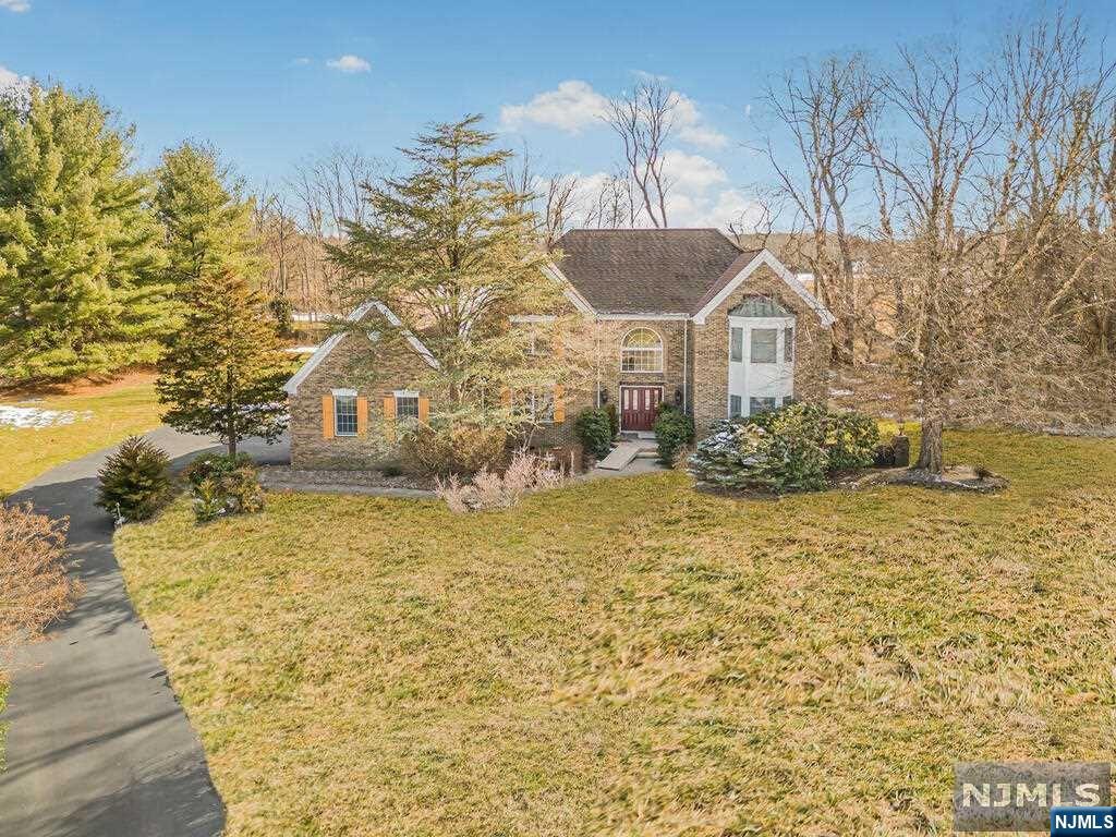 Exquisite custom center hall colonial nestled in South Brunswick with over 3,600 sq ft on a serene 1.33-acre lot. The entrance foyer, awash in natural light, leads to a sophisticated living room with 91/2 foot ceilings & hardwood floors, & a dining room adorned with tray ceilings. The heart of the home, a gourmet kitchen, features a 5-burner center island, 41" cabinets, & coriander countertops, opening to a family room with a cozy fireplace & wet bar. Upstairs, the master suite offers vaulted ceilings & a luxurious jacuzzi bath, accompanied by 3 additional bedrooms & a bath. Semi-finished basement provides ample space for storage & entertainment. This home is equipped with a 3-car garage, sophisticated security, & keyless entry. Prime location w/ easy access to Rt 18, Rt 1, NJ Tpk, & close to top schools, including Brooks Crossing Elementary, Crossroads Middle School, & South Brunswick High School, alongside shopping, dining, & natural retreats like parks/golf courses. A must see!