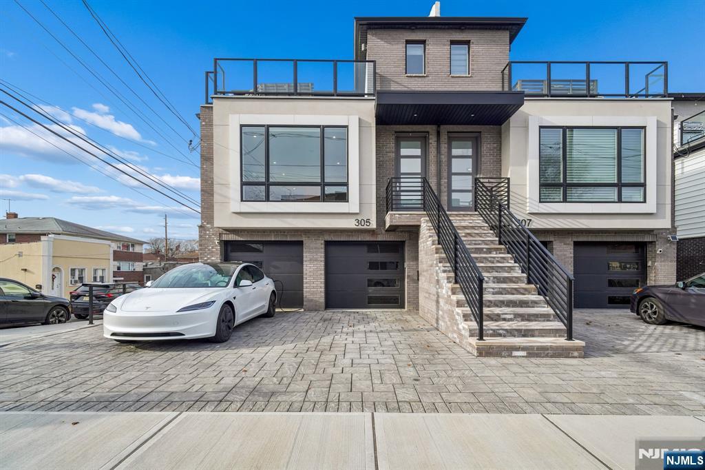 Welcome to this turnkey, low-maintenance newer-construction townhouse set along New Jerseyâ€™s highly sought-after Gold Coastâ€”offering a level of private outdoor living rarely found in the area. The highlight: your own private roof deck featuring an exclusive built-in outdoor kitchen and BBQ, ideal for entertaining, al fresco dining, or unwinding under the city skyline. Inside, modern design meets refined luxury across three bedrooms and two-and-a-half baths. A sun-drenched, open-concept layout is enhanced by wide-plank hardwood floors, recessed lighting, and thoughtfully curated finishes throughout. The chefâ€™s kitchen is both striking and functional, showcasing quartz countertops, custom cabinetry, Cafe 233; stainless steel appliances, and a statement center island perfect for everyday living and hosting. The primary suite offers a serene retreat with generous proportions and a spa-inspired en-suite bath complete with a double vanity and glass-enclosed shower. Additional bedrooms provide flexibility for guests, a home office, or extended living space. Notable features include garage parking, in-unit laundry, central air and heat, auto shades, and a bold contemporary exteriorâ€”delivering true move-in-ready convenience. Perfectly positioned in the heart of the Gold Coast corridor, just moments from shopping, dining, parks, and seamless transportation to New York City, this home offers an elevated indoor-outdoor lifestyle with exceptional accessibility.