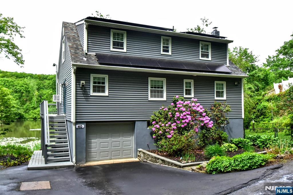 Welcome to this charming, updated Cape Cod home in the tranquil Shady Lake neighborhood of West Milford, New Jersey. This beautiful residence offers 4 bedrooms and 2 full bathrooms, Fully paid off Solar panels, plus a fully furnished basement for added living space. With a classic Cape Cod design and modern updates, this lakefront gem with a wraparound porch offers peaceful living just steps from the water. Don't miss this rare opportunity!