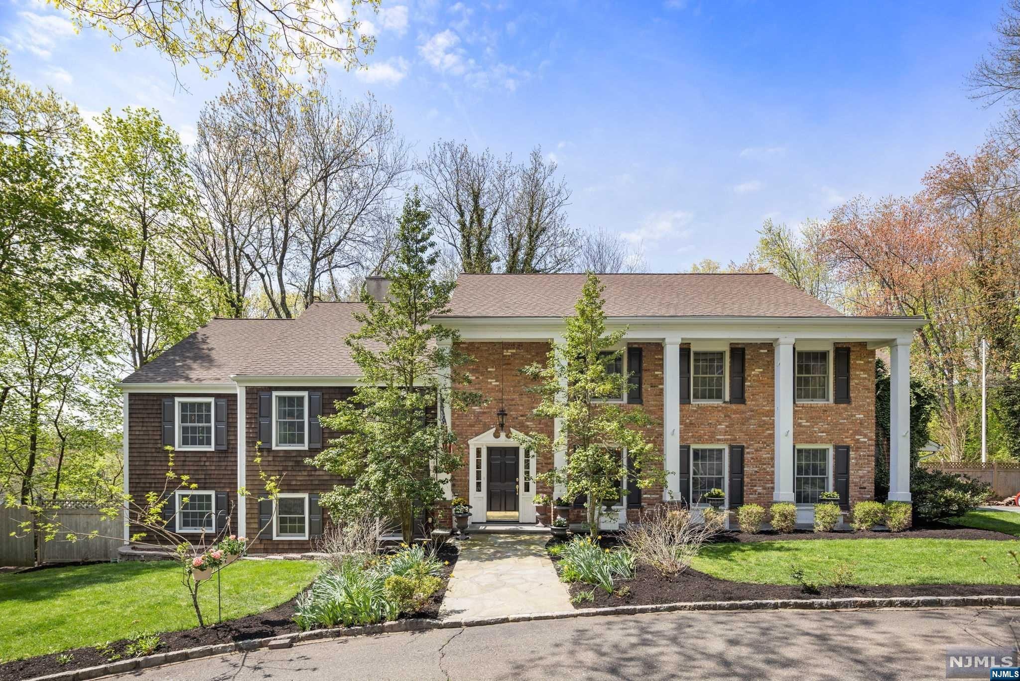Welcome home to this charming 5 bed/4 bath custom colonial in the beautiful, historic, and sought-after neighborhood of Holmehill in Roseland. Natural light throughout the 5300+ square feet. The foyer leads into an expansive library/office with custom bookshelves. The main living and dining area boasting open space with beautiful hardwood floors that flows into the eat-in kitchen where you can enjoy cooking, entertaining, and overlooking the park-like backyard. Upstairs you will find 4 large bedrooms each with ample closet space, an unfinished bonus room / walk-up storage space. The 5th large bedroom features a private ensuite bathroom, access to the laundry room, and private entrance into the home. The lower level of the home has a fully finished walk-out basement featuring a wood burning fireplace and a spacious recreation room that leads to a second stone patio surrounded by beautiful gardens.