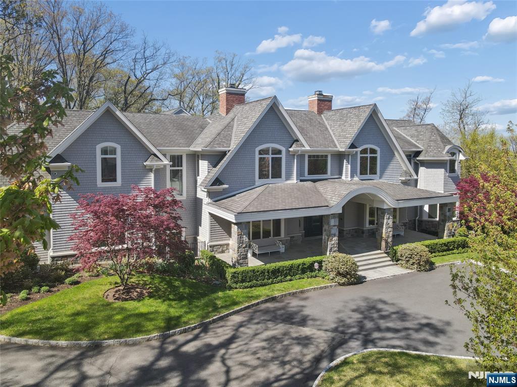 Perched high on Englewoodâ€™s coveted East Hill, this exceptional Hamptons-inspired estate offers a refined luxury lifestyle defined by impeccable craftsmanship & cutting-edge design. A dramatic entry introduces richly appointed interiors w/extensive millwork, custom wall coverings, Venetian plaster & lacquer finishes throughout the main living spaces. The gourmet kitchen is a true showpiece, featuring bespoke cabinetry, marble countertops, three sinks, dual dishwashers, & multiple Sub-Zero refrigeration units. A fully integrated Lutron system controls lighting & shades, & a comprehensive A/V & CCTV system w/15+ cameras ensures modern convenience & security. The main level includes a private bedroom suite, distinguished office w/cerused oak built-ins, & seamless indoor-outdoor living with a covered patio complete with fireplace & Phantom screens. Radiant heat extends throughout, including beneath wide-plank oak flooring. Upstairs, 6 en-suite bedrooms include a breathtaking primary suite w/spa-caliber marble bath and a custom Anegre wood dressing room. The walk-out lower level is designed for entertaining, offering two additional en-suite bedrooms, a temperature-controlled wine room, catering kitchen, glass-enclosed gym, & expansive recreation space. Resort-style grounds showcase a pool and spa with electric cover, bluestone patios, outdoor kitchen with NanoWall system, and professionally landscaped grounds with Synlawn turf area for kids. A truly extraordinary offering.