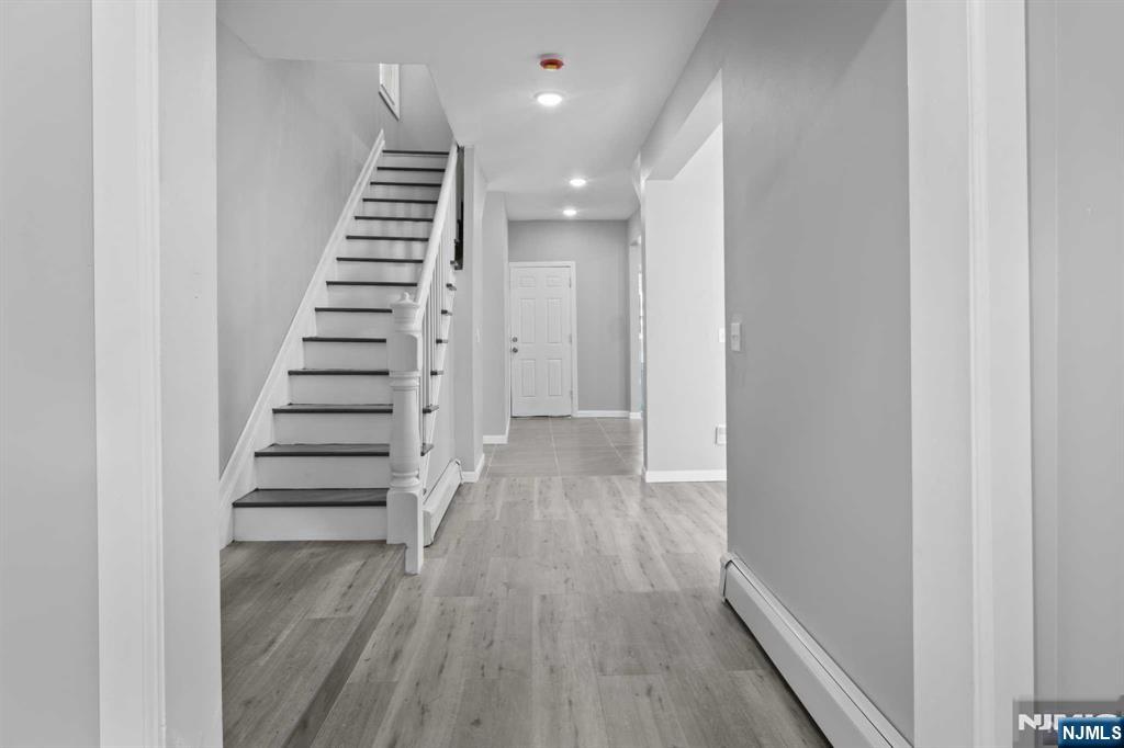 Welcome to East Orange, New Jersey's 20 Essex St. This three-bedroom house has just undergone a complete renovation and has several upgrades! Savor the ample space of the kitchen with its enormous, wide-open windows providing ample natural light! In addition, the home's dining space features refinished hardwood and new doors, carpeting, and improved lighting throughout the whole house.