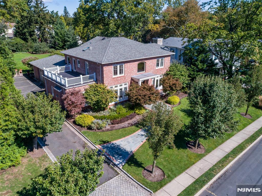 Spectacular One-of-a-Kind Brick Center Hall Colonial Custom built in 2004, this exceptional home features luxurious finishes and thoughtful design throughout. The main level offers a dramatic two-story foyer, formal living room with fireplace, elegant dining room, and a gourmet chefâ€™s kitchen with top-of-the-line stainless steel appliances, custom cherry cabinetry, breakfast area, and butlerâ€™s pantry with access to the patioâ€”perfect for indoor/outdoor entertaining. Spacious family room with fireplace plus a private in-law suite with full bath and powder room complete the first floor. See Virtual tour for more information.... The second level features a luxurious primary suite with study, private terrace, and spa-like bath, along with three additional bedrooms (two with terraces) and a hallway bath. The expansive lower level offers over 2,000 sq. ft. of entertainment space with 9â€™ ceilings, recreation area, Italian Pedini wet kitchen, wine storage, sauna, gym, full bath, and laundry. Additional highlights include radiant heat, hardwood floors, Pella windows, crown molding, 10-zone heat, 3-zone central air, central vacuum, EV charger, sprinkler system, and a 2-car garage. Ideally located close to schools, downtown, and transportation.