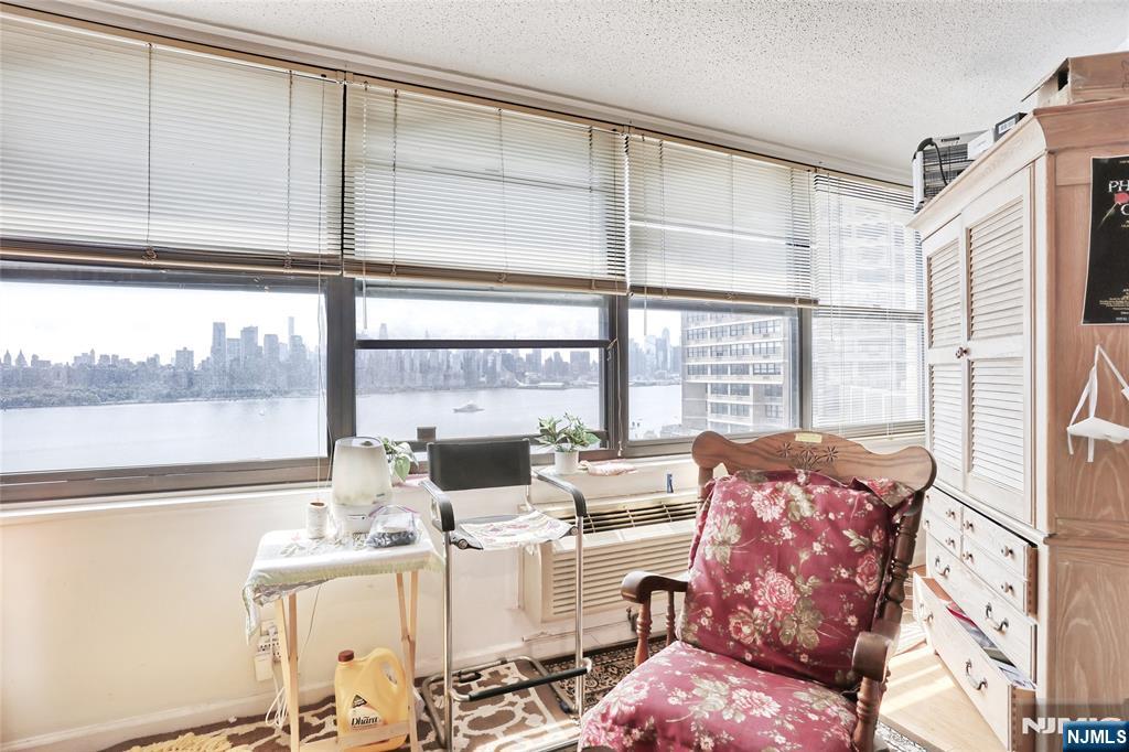 Donâ€™t Miss this Opportunity for a Spectacular View and Location in Tower 3! Experience stunning River and Manhattan skyline views from this beautifully updated one-bedroom condominium at the renowned Galaxy Towers. This home welcomes you with a foyer and powder room leading to a bright living/dining area, accented by track lighting and custom built-in shelves. The modern open kitchen boasts new stainless steel appliances and granite countertops. The oversized bedroom includes a private en-suite bath, large closet, and sun-filled solarium. Hardwood floors throughout add warmth and style. Enjoy full-service, resort-style living with a 24-hour attended lobby, state-of-the-art fitness center, and full spa with sauna, steam, and meeting rooms. Amenities include indoor/outdoor pools, tennis & pickleball courts, on-site shops, grocery store, restaurant, pharmacy, and dry cleanersâ€”plus the spectacular rooftop garden mini-park. Indoor parking available (fee). Pets welcome! Just steps away is James J. Braddock Hudson County Park, a 167-acre urban oasis with lakes, walking trails, sports facilities, and breathtaking NYC skyline views. Learn more about Galaxy Towers living https://www.thegalaxytowers.com/lifeatthegalaxy Maintenance includes all utilities except cable/internet. Excellent location with easy access to shopping, public transit, NY Waterway Ferry, and Light Rail.