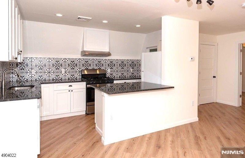 Welcome to 204 Hillside - a beautifully renovated one-bedroom loft-like apartment in the heart of Glen Ridge! Open plan living plus dining feature new wood floors throughout. The modern kitchen has stainless steel appliances, charcoal granite with counter seating, and designer tile. The bedroom with French doors and two large closets overlooks a tree-lined street. New windows, natural light, central air, and your own washer/dryer in a spacious, private storage area! Off-street parking, New York City train/bus two blocks away. Tenant occupied. Confirmed appointment and notice required. **Please note photos are from a previous listing.**