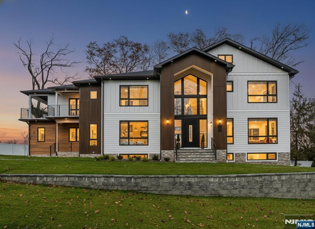 Experience Modern Luxury Redefined in this Stunning Masterpiece, Built and Designed by the renowned NJGCB, an award winning leader in Modern Architecture. Nestled at the end of a quiet cul-de-sac, this New Construction home offers up both privacy & breathtaking water and golf course views. Thoughtfully designed w/ exceptional craftsmanship, this custom home features 6 beds, 6.1 baths, 3 Car spanning over 6,700 sq ft of finished living space. Grand foyer welcomes you with massive floor to ceiling windows, floating staircase & herringbone HW floors. The heart of this home is your gourmet kitchen, where every element was meticulously crafted. Professional grade SS appliances, an abundance of sleek custom cabinetry, center island & walk-in Pantry. Kitchen opens to an impressive 2 story Family Rm w/gas FP, soaring ceilings, skylights & oversized sliding doors leading to outdoor deck, perfect for Entertaining. Elegant butler's pantry connects kitchen w/ Formal Dining Room, blending luxury with functionality. A First Floor Guest Suite offers convenience & accessibility. A beautifully appointed Primary Retreat w/ Covered Balcony, Custom Closets & Spa Inspired Bath w/dual showers & soaking tub. Three additional En Suite Beds & Laundry. Above Ground walk-out basement, filled with sunlight includes Media Rm, Bedroom, Bath, Gym, Office, Wet Bar & Rec Room. Two sets of Sliding Doors leads to paver patio & fenced in yard w/room & approvals for future pool. Luxury Living at its Best.