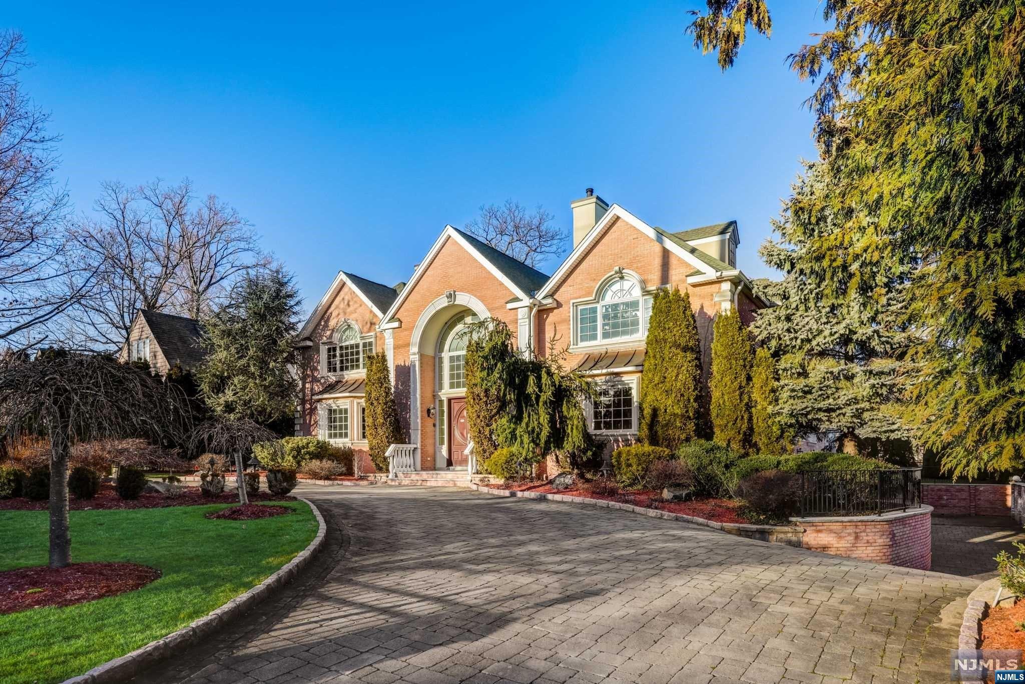 Experience unparalleled luxury in this meticulously crafted all-brick colonial, custom-built in 2006, spanning over 9,000 sq.ft. with basement. Nestled in the prestigious north side of Englewood Cliffs, moments from NYC, this residence offers six bedrooms, six full baths, & three half baths, including a main-level en-suite. The gourmet kitchen, with top-of-the-line appliances, a charming breakfast nook, & a butler's pantry, is perfect for entertaining. A grand foyer leads to a 32-foot great room with a dual gas fireplace, office, dining, & living rooms, adorned with stunning hardwood flooring. Upstairs,find four en-suite bedrooms & a lavish primary suite. The lower level boasts additional living space. Modern amenities include an elevator, 14-zone heating, 7-zone C/A,& a full house generator. Outside, a circular driveway & concrete balusters add elegance, while a 5-zone sprinkler system ensures lush landscaping. Experience the epitome of luxury living in this timeless masterpiece.