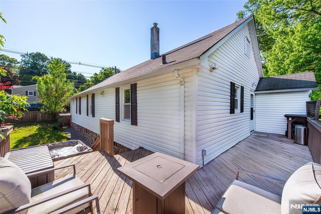 Welcome to this 3 bedroom, 1 bath ranch where comfort, space, and one of Bergen County's most sought-after communities come together. Gleaming hardwood floors, an open kitchen and dining area bathed in natural light, and a wood-burning fireplace make every day feel like home. Step outside to your private backyard retreat: a spacious deck, hot tub, and lush fenced yard surrounded by mature trees. The full unfinished basement is ready for your vision. Central air keeps you cool all summer. Commuters will love the short distance to the NJ Transit station with service to NYC. Hillsdale is known for its top-rated schools, from its highly regarded elementary schools through Pascack Valley High School, consistently recognized as one of the best in New Jersey.