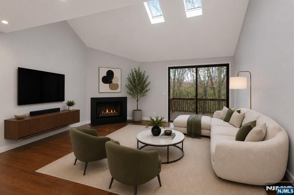 Beautifully updated 1,718sf, 2bedroom, 2.5bath duplex in the highly sought-after gated Harmon Cove, just minutes from NYC. This home features vaulted ceilings with skylights, hardwood flooring throughout, and an open floor plan. Sunken living room with wood-burning fireplace and sliding glass doors to a private balcony overlooking a park-like setting. The eat-in kitchen features stainless steel appliances, ample cabinetry, generous counter space, and a center island. It opens to a versatile bonus room, ideal as a family room, home office, playroom, or potential third bedroom. A formal dining room and updated powder room complete the main level. Upstairs, both bedroom suites feature walk-in closets and private full baths. The bathrooms were fully renovated last fall with custom stone-top vanities, LED anti-fog mirrors, and rainfall shower systems. In-unit GE Profile washer/dryer, Wi-Fi-enabled skylight shades, and a new LED ceiling fan/light with remote in the primary bedroom. Two covered parking spaces and private storage. Resort-style amenities include adult and kiddie pools, clubhouse with cafe/bar, tennis, pickleball, basketball courts, playground, marina, trails, and 24/7 gated security. Walking distance to school bus, NJ Transit bus to Manhattan, and shuttle to Secaucus Junction. Minutes from American Dream. HOA includes amenities, water, master insurance, landscaping, snow removal, and trash collection. (Furniture shown in photos has been virtually staged.)