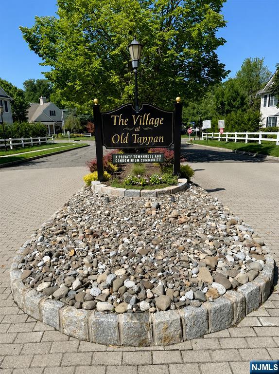 End unit adjacent to the picturesque pond and gazebo located in The Village at Old Tappan, one of Bergen County's most sought-after active communities, offering a resort-style lifestyle in a park-like setting. Designed for residents seeking low-maintenance living without sacrificing comfort or amenities, the community features a collection of well-appointed townhouse-style condominiums surrounded by landscaped grounds, scenic ponds, walking paths, and tranquil open spaces. Enjoy an impressive array of amenities, including a clubhouse with gathering and recreation areas, a fitness center, outdoor swimming pool, playground, bocce court, and a fenced dog run. Entry foyer, living room w/gas fireplace, dining room, slider to deck overlooking brook, primary bedroom w/two large closets, primary full bath, second bedroom, full bath, kitchen, laundry area, exit to garage from laundry area. Lower level features large family room, office space/extra guest bedroom, full bath, generous storage area and mechanical room. A standout feature of this home is the tranquil babbling brook just beyond the back deck, where the gentle sounds of flowing water provide a peaceful soundtrack to everyday living, a rare and inviting natural amenity. Minutes to Old Tappan Golf Course, shopping, dining, places of worship and major commuter routes. Top-rated Old Tappan school district.