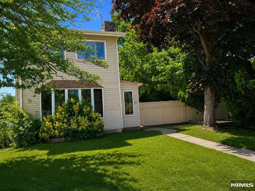 Charming 2-story Colonial on a private 50' x 100' lot backing to woods. Enjoy outdoor living with a paver patio, deck, and above-ground pool (As is). The eat-in kitchen features wood cabinetry and a chef-quality gas range, while the spacious formal dining room and living room with a fieldstone wood-burning fireplace are perfect for entertaining. High-end hardwood floors enhance the main level. The oversized primary suite offers ample space for a king-size bedroom set and features a private bath with a jetted tub. Additional highlights include a high-ceiling basement ideal for storage, a workshop, or home gym, first-floor laundry, a multi-zone boiler, tankless water heater, central air on the second floor, and a mini-split system on the first floor. Conveniently located just 1.7 miles from Garden State Parkway Exit 120 and minutes from Laurence Harbor's waterfront park, fishing piers, and boardwalk.