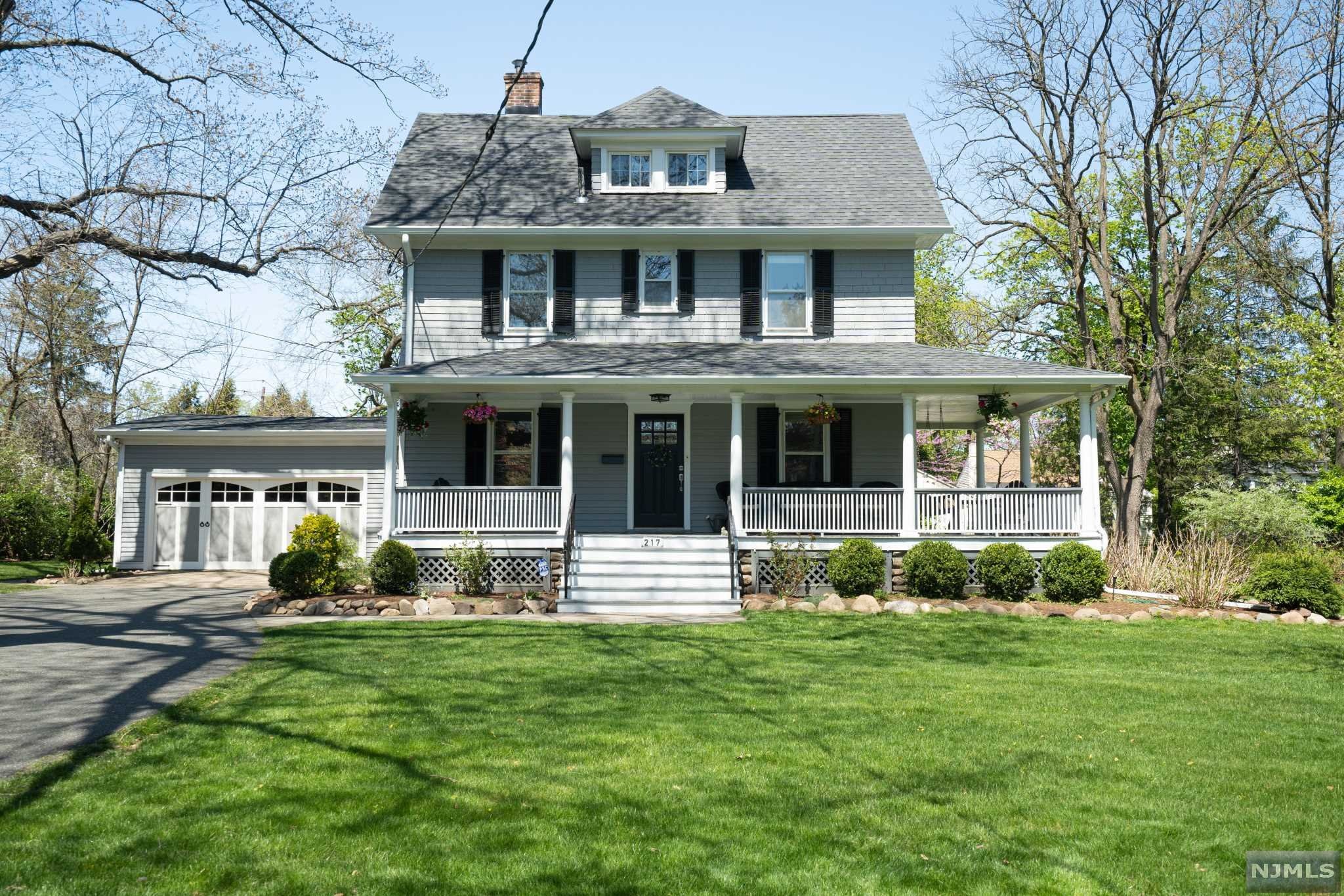 Steps away from downtown Ho-Ho-Kus and the train or bus into New York City. Nestled on a half acre lot ringed by hedges and trees for privacy, this colonial/victorian charmer invites you in with its large wraparound porch promising summer evenings of cold drinks accompanied by the soothing sound of water from the Ho-Ho-Kus brook. The view from the porch is a stunning landscape of large flowering hydrangeas, manicured trees from Japanese maples, dogwoods, and a seven brothers tree offering you your own private arboretum. Lots of room to make the garden/yard of your dreams. The house boasts 5 bedrooms and 2.5 baths with original hardwood floors and charm throughout. There is a large attic ready to be finished for a bonus room/bedroom. The updated kitchen is open to the great room which boasts a wood burning fireplace and large sliding doors out to the finished patio and landscaped yard, ideal for entertaining. Well maintained charmer with updates, your entry into Ho-Ho-Kus awaits!