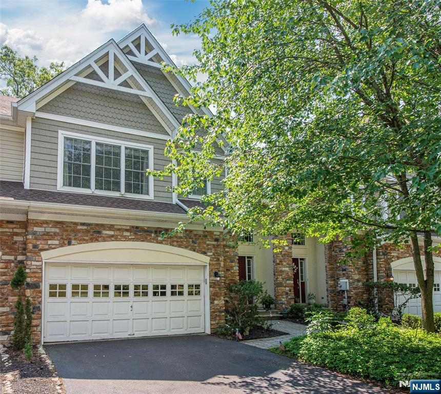 Welcome to this beautifully appointed 2,300 square foot townhouse in a rarely available location in the Ramapo River Reserve. This 2 bedroom, 2 full bath, and 2 half bath is located in a private, picturesque setting. The open concept main level is designed for both everyday living and entertaining, featuring a dramatic great room with soaring ceilings, expansive windows that fill the home with natural light and a cozy gas fireplace. The spacious kitchen boasts a large center island, abundant cabinetry, a separate eat-in area that flows seamlessly into the dining room, creating the perfect gathering space. Rich hardwood floors enhance the homeâ€™s warmth and elegance. Upstairs you will find a large primary suite with an oversized bathroom with deep soaking tub and extra large walk-in closet, an additional bedroom with an en-suite full bathroom and second floor laundry. Step outside to the private deck or lower level patio overlooking peaceful treetops, offering a tranquil retreat for morning coffee or evening relaxation. Additional highlights include a two car garage, plenty of storage space, newer roof and gutters and an alarm system. The community offers walking trails along the river, pool, clubhouse with gym and playground. Enjoy living in The Ramapo River Reserve known for its rolling hills, mountain views and low-maintenance living.