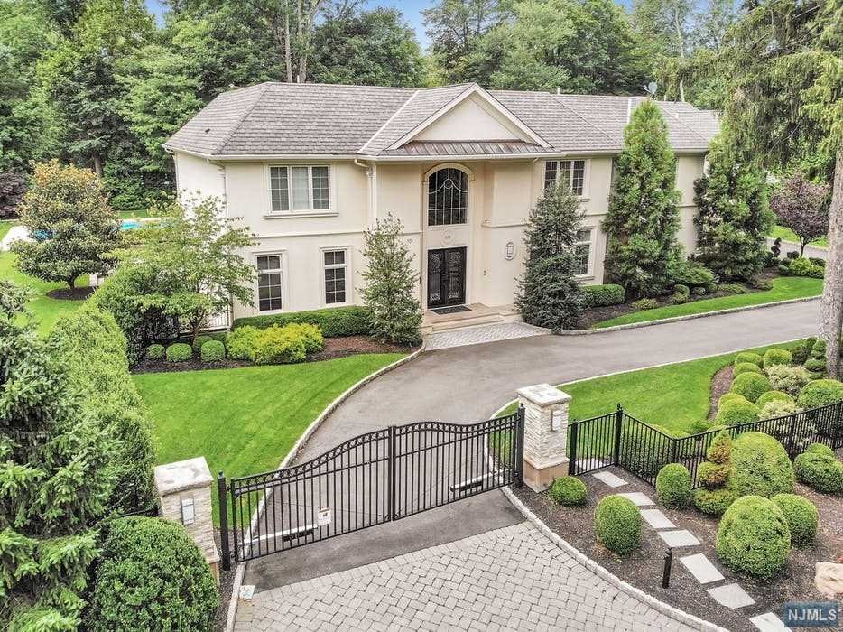 2015 Modern French inspired smart-house estate located on 1.2 acres with impressive front gates and mature landscaping on dead end street. The interiors are open, sunny and bright. Breathtaking entry foyer, handmade cherry office and large double living room with fireplace have views of the property. Open Chef's kitchen is the heart of the house with custom white glazed cabinets, white marble counter tops, Viking appliances and large eat-in area. Stunning 2nd floor Main bedroom en suite with granite fireplace, large dressing room and marble bath with additional 4 large bedrooms and laundry room. Other bedroom en suites located on the main floor and lower level. All bathrooms exceptional modern design. Lower level with family room, wet bar, wellness spa with gym, wine cellar and game room. Stunning and private out-door space includes large rolling lawns, modern designed pool with spa and multiple entertaining areas. Home can be sold furnished. Stunning home and minutes from NYC!