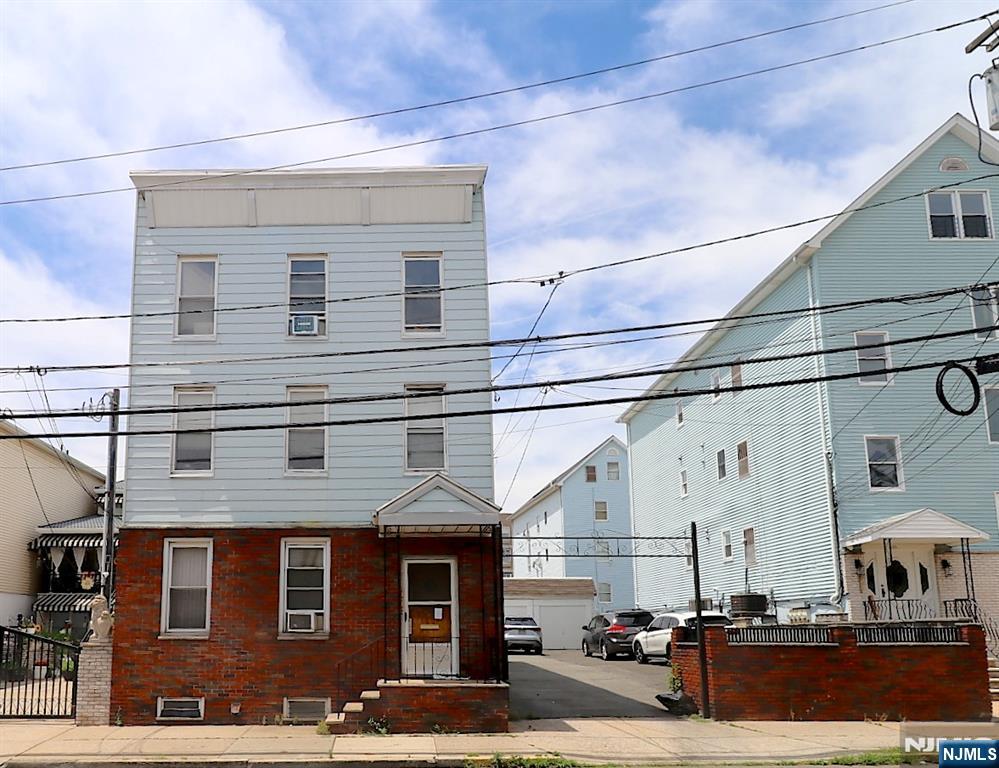 Great Investment Opportunity â€“ Package Deal: Three-Family Home + 25' x 100' Lot in Newark's Ironbound District. Located in one of Newark's most desirable neighborhoods, the Ironbound, this unique package deal offers tremendous potential for investors, developers, or owner-occupants. Just a few blocks from Newark Penn Station, you'll enjoy convenient access to New York City with an approximately 20-minute train ride to Manhattan. The property is also minutes from the vibrant Ferry Street district, known for its outstanding restaurants, shops, and lively atmosphere. These three-family fixer-upper features, on each floor: Kitchen, Living room, Two bedrooms, Full bathroom. Additional highlights include: a finished basement with laundry and utility room One heating system with four zones, rare blacktop driveway with five-car garage parking Whether you're looking to renovate, generate rental income, or pursue redevelopment opportunities, this property presents outstanding potential in a highly sought-after location. Included a 25' x 100' lot, offering additional value and future possibilities Don't miss this chance to own a valuable property in Newark's thriving Ironbound neighborhood.