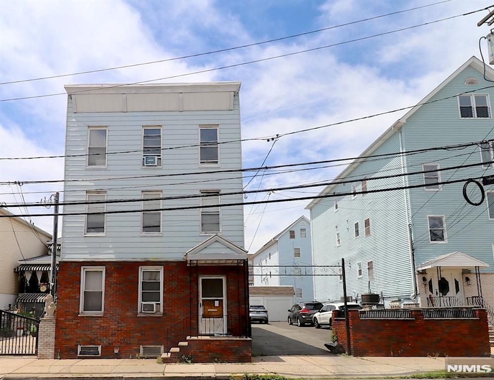 Great Investment Opportunity â€“ Package Deal: Three-Family Home + 25' x 100' Lot in Newark's Ironbound District. Located in one of Newark's most desirable neighborhoods, the Ironbound, this unique package deal offers tremendous potential for investors, developers, or owner-occupants. Just a few blocks from Newark Penn Station, you'll enjoy convenient access to New York City with an approximately 20-minute train ride to Manhattan. The property is also minutes from the vibrant Ferry Street district, known for its outstanding restaurants, shops, and lively atmosphere. These three-family fixer-upper features, on each floor: Kitchen, Living room, Two bedrooms, Full bathroom. Additional highlights include: a finished basement with laundry and utility room One heating system with four zones, rare blacktop driveway with five-car garage parking Whether you're looking to renovate, generate rental income, or pursue redevelopment opportunities, this property presents outstanding potential in a highly sought-after location. Included a 25' x 100' lot, offering additional value and future possibilities Don't miss this chance to own a valuable property in Newark's thriving Ironbound neighborhood.