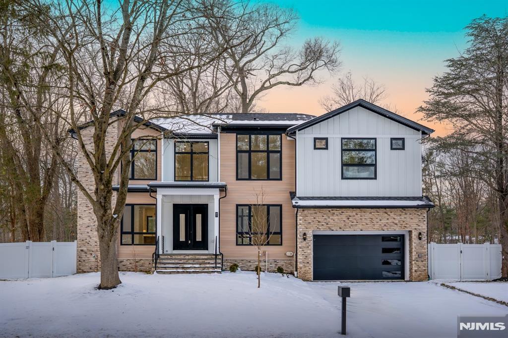 Brand New Construction by NJGCB, a leader in Modern Architecture and Design. Contemporary Style meets Luxurious Living in this stunning Custom Smart Home with over 5,200 sq ft of livable space spanning three levels. An Impressive Home with Floor to Ceiling Windows, Modern Glass Staircases, and Open Concept Living. First Floor w/10ft Ceilings, Formal Living Rm, Formal Dining Rm, Large Two-Story Height Family Room with skylights and Gas FP. Sliders leading from Family Room to Deck and Stone Patio - creating a seamless indoor outdoor flow for entertaining and relaxing in front of your outdoor Fire Place. A thoughtfully appointed Gourmet Kitchen w/ High End SS Appliances, Walk-in Pantry, Custom Cabinetry & Large Center Island w/Quartz Waterfall - perfect for hosting formal dinners or casual gatherings. First Floor Guest Suite w/ Bedroom & Full Bath, Mudroom & Powder Room complete first floor. A Luxurious Primary Suite w/tray Ceilings, Private Balcony, Custom WIC's and a Tranquil Spa Bath w/soaking tub, Dual Vanity and Water Closet. Three additional large En Suite bedrooms, each with their own walk-in closet and full bath. A Fully Finished Walk-out Basement with 9ft ceilings includes a 6th Bed, Full Bath, Media Room w/ soundproofing & speakers, Rec Room, Wet Bar & Home Office/Gym. Landscaping package includes Sod, Irrigation System, Paver Patio, Deck, Outdoor Fireplace and fully fenced in Yard. Plenty of room for Future Pool. A Modern Masterpiece of Contemporary Design.
