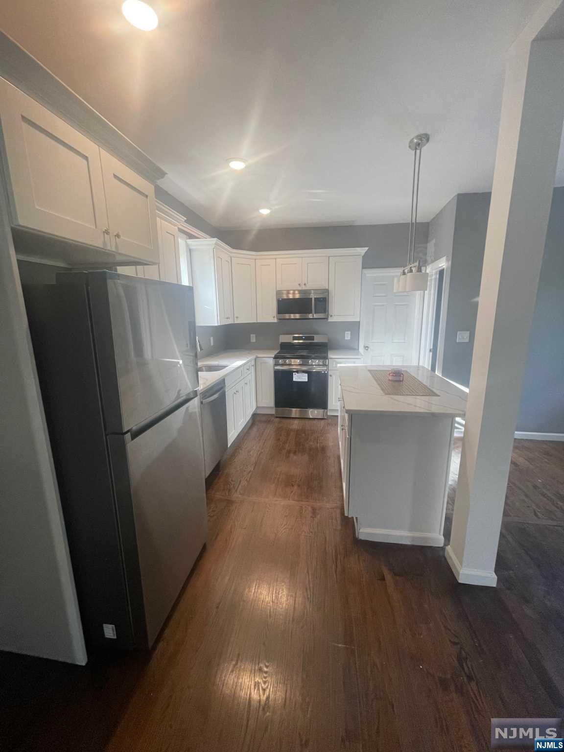 Fully renovated two family home. Both apartments have an open floor plan, including living room, dining room, 2 bedrooms, full bath and kitchen with quartz countertops and SS appliances. The first floor apartment has a full finished basement with laundry hookup. Close to transportation, Restaurants, Schools, 7 parking spaces...