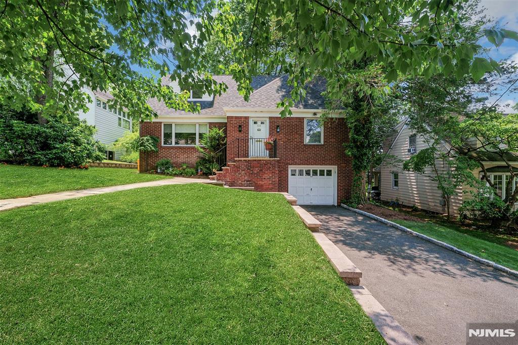 Very spacious expanded cape in prime West Englewood location. Formal living room and dining room, kitchen with large breakfast area and built in desk/office, gorgeous sun drenched family room with two skylights, 15 foot ceiling, multi windowed wall overlooking landscaped yard, and sliding glass doors to deck. First floor master bedroom with full bath (stall shower) and an additional half bath off the family room complete the first floor. Second floor has three bedrooms and a full bath plus great attic storage thru one of the bedrooms. The finished basement has a play room, office, laundry, entrance to one car garage, plus a huge unfinished storage room under the den. Closets galore, ug sprinklers, central air, alarm, hardwood floors, updated windows, newer roof and new hot water heater. Close to houses of worship, transportation, parks, shopping.
