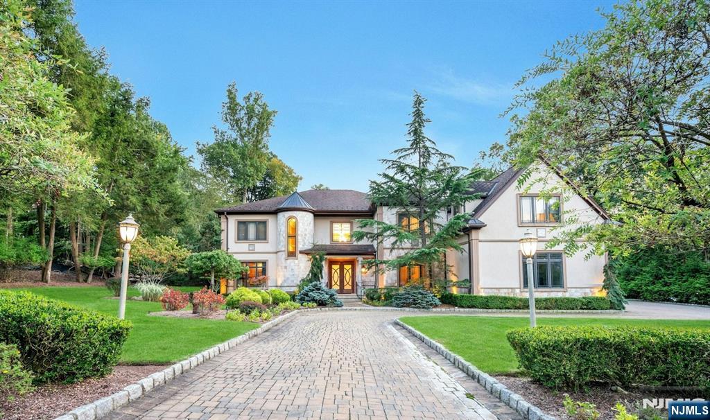 Experience the ultimate family retreat in Upper Saddle River, where elegance meets comfort in this quality-built home. Custom designed windows and millwork, special materials from Europe throughout, and the architecture speaks for itself. Designed for both relaxation and entertaining, the home features six spacious bedrooms-including two primary suites and an elevator servicing all 3 levels. The gourmet kitchen flows into the family room, leading to a beautiful bluestone terrace complete with an outdoor kitchen, perfect for gatherings. The impressive lower level offers a professional theater, bar, wine room, kitchen, gym, and sauna. Outside, the heated Gunite pool with a waterfall, swim-up bar, and open cabana with TV create the perfect entertainment setting, surrounded by a blue stone patio, and a large, lush lawn for outdoor activities. A magical place to call home.