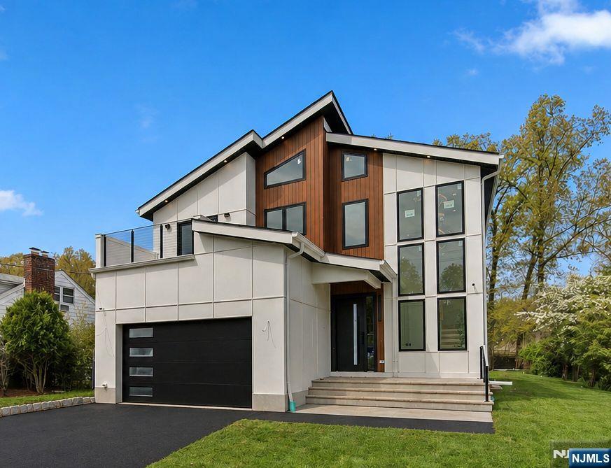 52 Congressional is an exceptional 3,350 sq ft new construction home offering 6 bedrooms and 5.5 bathrooms, thoughtfully designed with refined luxury and modern comfort. A welcoming entry leads into an open-concept layout ideal for everyday living and upscale entertaining. Formal dining spaces provide an elegant setting for gatherings, complemented by a stylish powder room. The chef's kitchen is a true showpiece, featuring a waterfall-edge quartz island and a seamless quartz backsplash crafted from the same stone for a sleek, cohesive look. Custom cabinetry and a full suite of Thermador stainless steel appliances complete the space. The open family room flows effortlessly to a spacious concrete tile patio overlooking a private backyard filled with natural light. Upstairs, the primary suite offers a serene retreat with two custom walk-in closets and a spa-inspired bath with dual vanities, a soaking tub, and a glass-enclosed shower, along with a private balcony. This level also includes an additional en-suite bedroom, two more bedrooms with a shared bath, an office/nursery, and a well-appointed laundry room with cabinetry and sink. The fully finished basement features high ceilings, a large recreation room, custom bar, media room, guest suite, and full bath. Additional highlights include a 2-car EV-ready garage, mudroom, in-ground sprinkler system, and a 10-year builder's warranty. Situated on an approx. 14,374 sq ft lot. All square footage is approximate.