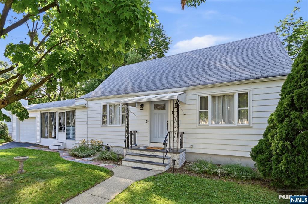 Beautifully maintained and updated Cape Cod style home with attached garage on a rare, oversized corner lot in Clifton's highly desirable Maple Valley neighborhood. The bright and inviting interior features a spacious living room, two first-floor bedrooms, a tastefully renovated full bath with modern finishes, an expanded eat-in kitchen, and an attached sunroom that can easily become a formal dining room to maximize your square footage. Upstairs offers a large third bedroom, abundant storage, and a bonus room ideal for a fourth bedroom, home office, guest space, or hobbies. The full, partially finished basement includes a laundry room and endless possibilities for a workshop, home gym, office, or additional finished living space. Central air throughout, updated electrical and plumbing, with natural gas already available in the home making future conversion from oil heat easy. Outside, enjoy a beautifully landscaped garden and spacious yard ideal for entertaining, gardening, or relaxing. Parking includes an attached garage, private driveway, and ample street parking. Conveniently located minutes from major highways, and within walking distance to the NYC bus, schools, shopping, restaurants, and parks. Enjoy the added benefit of being just moments from Montclair's acclaimed dining, entertainment, and university-all while enjoying the lower taxes of Clifton living.