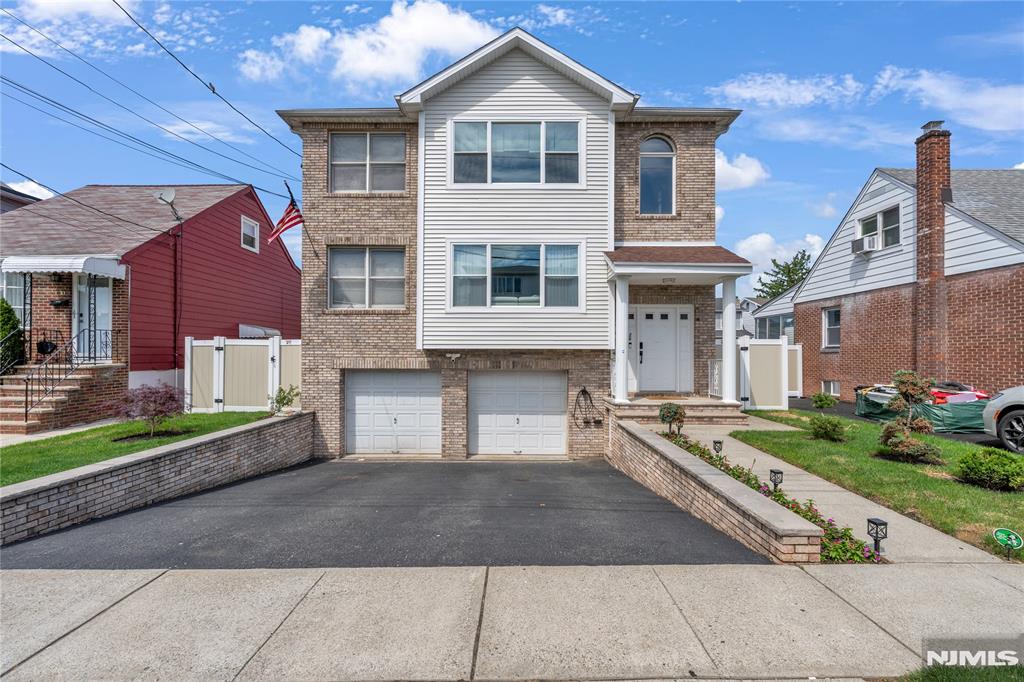 2-family w/2-car built-in garage & driveway for 2 cars, located a block away from the NYC Bus stop! This conveniently located home, built in 2002, was recently updated. Each unit has a Living room, dining room, new kitchen, 3 bedrooms, and 2 updated bathrooms on each floor. Primary bedrooms have a private full bath & walk-in closet. The 2nd-floor unit has a laundry closet in unit. Ground level is finished with a recreation room, family room, full bath, laundry room, and access to a 2-car garage. Hardwood floors, tiled baths, and kitchens have quartz tops and tiled backsplash. 2 separate gas forced hot air heating and central air systems (1st floor has 2 zones-1 for 1st floor & 1 for ground level), 2 water heaters, and 2 separate electric and gas meters. 1st floor its owner occupied. 2nd floor currently is tenant occupied, moving out end of June- both units will be delivered vacant at the closing. New deck off the 1st floor kitchen leading to a new above-ground pool and lovely fenced-in yard. Not a flood zone.