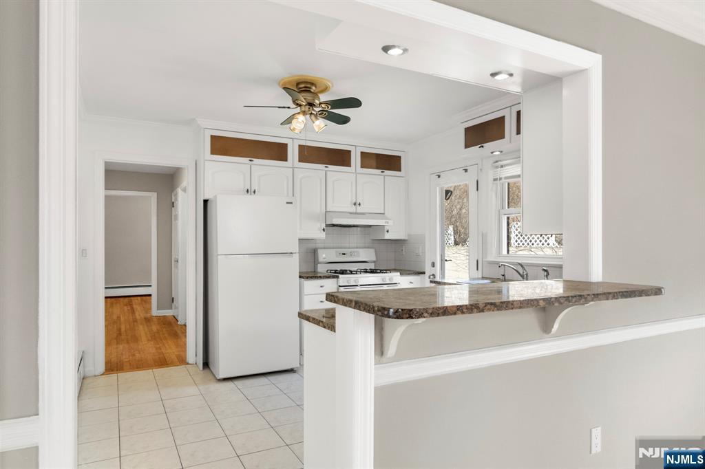 WELCOME TO 769 CYPRESS STREET, A WELL-MAINTAINED ALL BRICK HOME NESTLED IN A QUIET RESIDENTIAL AREA...THIS CHARMING OFFERS 4 BEDROOMS AND 3 FULL BATHROOMS... AS YOU ENTER, YOU'LL BE GREETED BY GLEAMING HARDWOOD FLOORS THAT FLOW THROUGHOUT THE MAIN LEVEL...THE SPACIOUS LIVING AREA FEATURES A DECORATIVE LIMESTONE FIREPLACE, CREATING A WARM AND INVITING ATMOSPHERE...THE UPDATED KITCHEN BOASTS GRANITE COUNTERTOPS AND CUSTOM MAPLE CABINETS WITH BUILT-IN LIGHTING, PROVIDING BOTH FUNCTIONALITY AND STYLE...THE HOME INCLUDES A FINISHED WALKOUT BASEMENT, PERFECT FOR ENTERTAINMENT OR ADDITIONAL LIVING SPACE... THIS STRUCTURE OF 3 LEVELS LIVING AREA THAT ADD UP TO OVER 2,600 SQFT...5 MINUTES TO NYC TRAIN.