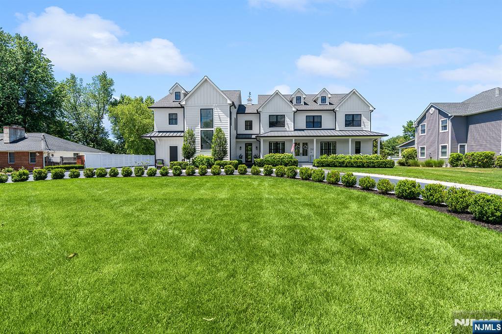 Architectural excellence meets everyday living in this extraordinary Modern Farmhouse completed in 2020. Custom-built as the owners' personal residence, the home offers nearly 8,000 sq ft of exceptional craftsmanship, luxury & versatility on nearly 3/4 of an acre. Designed for both grand entertaining & comfortable daily living, every detail reflects uncompromising quality including Premium Marvin Integrity windows/doors, James Hardie siding, Azek trim, radiant heated Versace tile floors throughout main level, and an elevator providing access to a beautifully appointed private suite. Live & entertain with ease as the home offers: a dramatic entry foyer, exquisite chef's kitchen w/ walk-in pantry, open LR w/ fireplace & custom built-ins, private office, den, sunken sunroom, beautifully appointed mudroom, open 2nd floor loft, 5 bedrooms, custom laundry room & luxurious primary suite w/ spa bath, walk-in closet & private balcony. The finished lower level features custom theater w/ wet bar, rec area, home gym, full bath & abundant storage. The 1,300 sq ft private suite offers its own entrance, balcony, cathedral ceilings, laundry, pantry & luxurious finishes, providing exceptional flexibility. A heated 3 car garage, patio, basketball court, batting cages, garden area, lower taxes & a prime Pompton Plains location with outstanding schools & convenient access to shopping, dining, and major highways truly complete this one-of-a-kind offering. Schedule your private tour today.