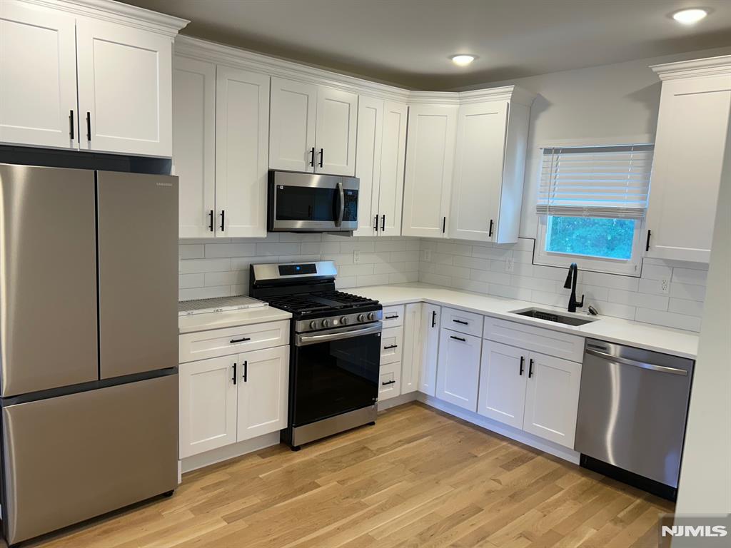 Beautiful totally renovated 2nd and 3rd floor apartment. This very large 2nd floor unit features Living room, Dining Room, Eat in Kitchen with stainless steel appliances (refrigerator, stove range, microwave vent, dishwasher), 2 large bedrooms, 1 full Baths, finished attic with 3rd Bedroom and washer and dryer inside unit. Schools, restaurants, shopping and parks are within walking distance plus NYC transportation is half a block away!