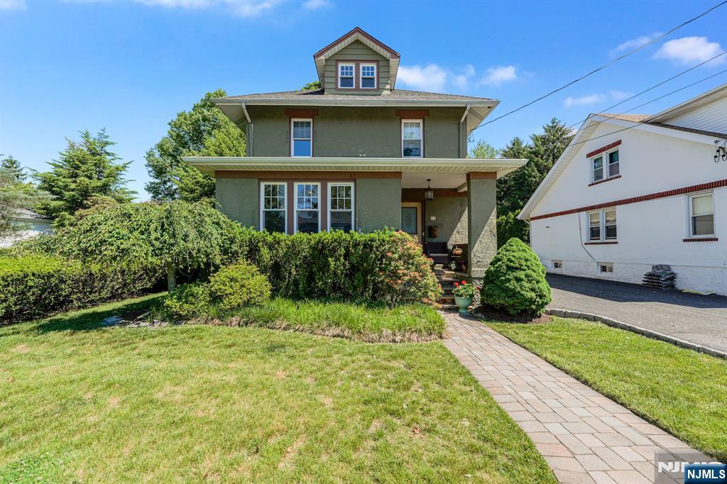 Charming Craftsman Colonial with beautiful cherry wood trim nestled on a picturesque tree-lined street in the heart of Emerson, seamlessly blending timeless character with a thoughtfully designed 2006 expansion. A welcoming foyer opens to a gracious sitting area, elegant LR, sunroom/office in front of LR, formal DR, and modern eat-in kitchen. The rear family room addition creates an inviting space for everyday living and effortless entertaining, complemented by a convenient powder room. French doors to very private patio and backyard. The second-floor features three bedrooms, a full bath, and a spacious primary suite addition offering a private retreat with generous proportions, an ensuite bath, and two walk-in closets. Additional highlights include a walk-up attic and partially finished basement with laundry, utilities, and ample storage. Equipped with Tesla charger as well. Ideally located near NYC transportation, schools, restaurants, and shopping, with the added benefit of Emersonâ€™s own school system.