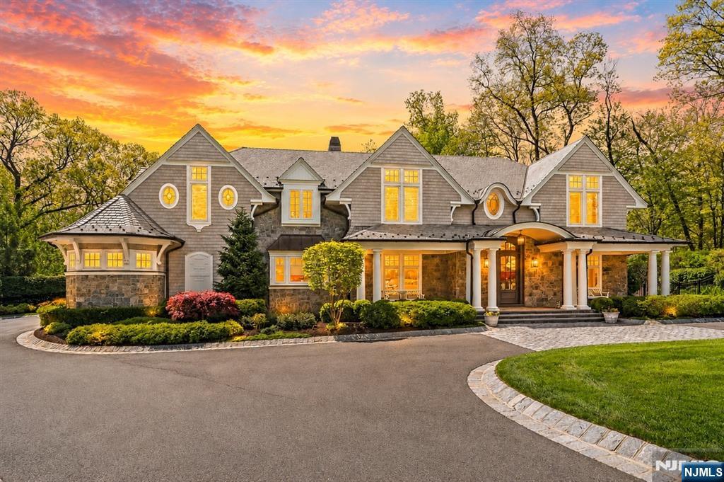 Spectacular Hampton-style custom residence built in 2018, set on nearly one acre of lush, professionally landscaped grounds offering a private retreat setting. This professionally designed luxury estate showcases impeccable craftsmanship and exceptional attention to detail throughout. The resort-style backyard features a heated pool/spa, outdoor living room w/fireplace, and outdoor kitchen, perfect for entertaining. Step into a dramatic two-story foyer, a living room/library, private office, formal dining room, and an impressive great room w/fireplace and stunning bar. The gourmet chef's kitchen features marble countertops, oversized center island, 8-burner Wolf range, two Sub-Zero refrigerators, three dishwashers, walk-in pantry, and a dining/sitting area w/fireplace. The first floor also includes a powder room, mudroom, laundry room, full bath, and access to the attached three-car garage and backyard. The second floor is highlighted by a magnificent primary suite featuring detailed vaulted ceilings, private sitting area w/fireplace, spa bath with steam shower, soaking tub, dual vanities and a custom-designed walk-in closet. Three additional ensuite bedrooms, gym and laundry room complete this level. The walkout lower level offers expansive living space with sitting/ game areas, full bath, bar, and space ready for a wine cellar. This home includes radiant heat throughout, elevator, and a generator. A rare offering combining exceptional amenities, and luxury living .