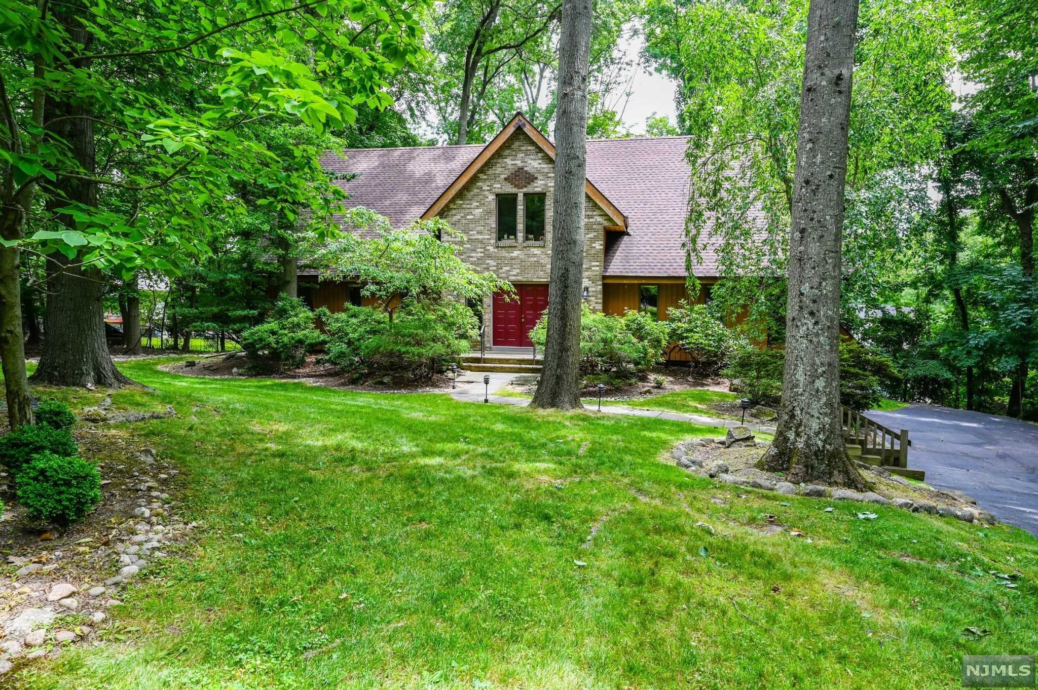 Welcome Home! Prime Montvale location set back off a quiet cul-de-sac. Private road leads you to a tranquil & secluded 1/2-acre+ property. Inviting Contemporary Colonial offering vaulted ceilings, spacious rooms & closet space throughout. Generous tiled entrance hallway leads to the living room & formal dining room with hardwood floors. Large center island kitchen with separate dining area, walk-in pantry, laundry room and sliding glass door to private deck. Magnificent 2 story Great rm featuring floor to ceiling stone gas fireplace. 1st floor bedroom/guest suite or 2nd primary bedroom with hall bath. The 2nd floor offers the primary BR with vaulted bath, 2 walk-in closets plus sitting area. Open balcony overlooking the Great room, 1 vaulted bedroom, 2 additional BR's and guest bath. New roof in 2016. Magnificent sunrise. A wonderful home that will not disappoint. Top rated town & schools with low taxes & easy commute to NYC by train or bus. Cls to Downtown shop/restaurants.