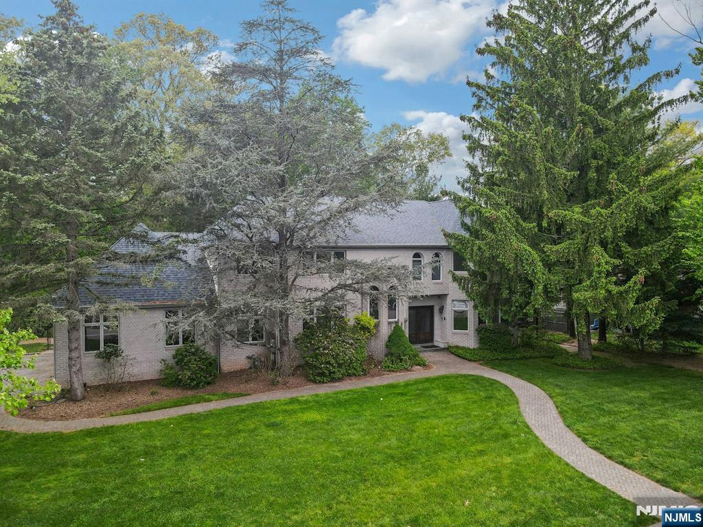 Exquisite 6-BR Center Hall Colonial with Expansive Floor Plan and Oasis Backyard in Old Tappan! Step into this gorgeous home featuring gleaming hardwood floors, high ceilings, and exceptional living space throughout. A grand two-story foyer with soaring ceilings welcomes you into this stunning home. The spacious family room, featuring a custom fireplace flows into the bright eat-in kitchen, which includes white cabinetry, granite countertops, a generously sized center island and sliding doors leading to resort living at its finest. A large formal living room/music room and banquet-sized dining room provide the perfect setting for entertaining. A large bedroom, two half baths, and a convenient mudroom complete the first level. On the second level, a lovely Juliet balcony overlooks the foyer below. The luxurious primary suite features a vaulted ceiling, dual custom closets, and a beautiful spa-like full bath with a double vanity, jetted tub, and separate shower. A large Junior suite with an updated full bath, three additional spacious bedrooms â€” two connected by a Jack-and-Jill full bath â€” along with a bonus room and laundry room complete this level. The expansive finished walk-out lower level offers a large recreation room, gym area, full bath with two separate showers, and abundant storage space. Lush, professionally landscaped property features a true oasis backyard with a gunite in-ground pool, paver patio, and deck â€” perfect for entertaining and outdoor enjoyment.