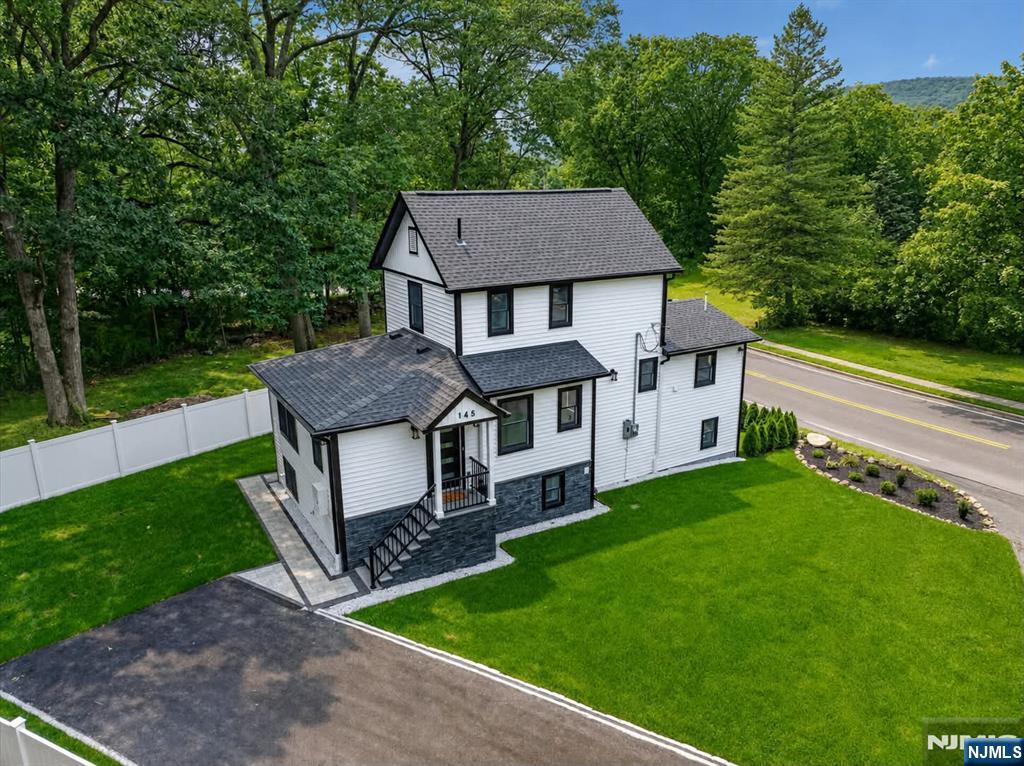 Completely renovated from top to bottom, this approx 2500 sq ft stunning home offers 4 bedrooms, 3 full and 1 half bath, combining modern design, and quality craftsmanship.Extensively renovated throughout, nearly every major component has been updated, including a new roof, Andersen windows, electrical, plumbing, HVAC, and a new 200-amp electrical service. A new driveway, professional landscaping, underground sprinklers, lush new sod, a composite deck, EV charger locker room, and a spacious paver patio create exceptional curb appeal and complete this remarkable transformation.Designed for today's lifestyle, the open-concept main level features a spacious living room, dining area, and beautifully appointed kitchen with shaker cabinetry, quartz countertops, stainless steel smart Wi-Fi appliances, a center island, and seamless flow for everyday living and entertaining. The highly desirable first-floor primary suite offers privacy and convenience with a beautifully finished en-suite bath.The thoughtfully designed floor plan provides exceptional comfort and functionality, with a bathroom on every level. The finished lower level adds living space and flexibility, making it ideal for extended family, guests, or a recreation room. Taxes are estimated to be between $8,000-$9,000 per Mahwah tax assessor, will be finalized in July. Lot size is 0.144 acre***WANT MORE INFO? CONTACT LISTING AGENT YVONNE MAYO @201-376-9849//YVONNE@MINETTIDENNISGROUP.COM