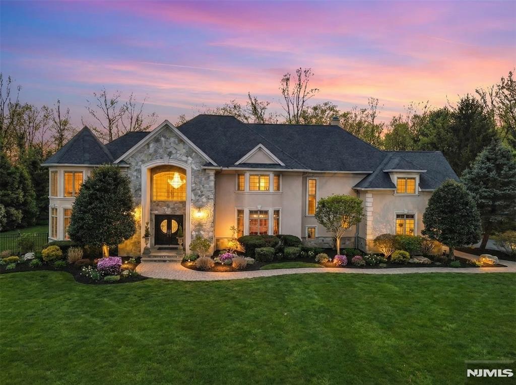 Welcome to 2 Stewart Court, a beautifully maintained residence tucked away on a quiet cul-de-sac in sought-after Old Tappan. Offering approximately 7,600 square feet of living space, this exceptional home includes a fully renovated 2,500-square-foot basement, featuring a wet bar, home theater, and versatile space ideal for entertaining. The home showcases a luxurious use of open volume throughout, highlighted by modern architectural lines and dramatic double-height ceilings in the entry foyer, great room, and primary suite. The great room is anchored by a wood-burning fireplace, creating a warm and inviting focal point. Enjoy picturesque views of Lake Tappan and stunning sunset vistas, while sun-filled interiors feature newly renovated bathrooms and new hardwood flooring throughout. Outdoor living is enhanced by a heated gunite pool with a brand-new pool cover. Recent updates completed within the last year include a new roof installed in January 2025 and a new hot water heater. Conveniently located near top-rated schools, parks, shopping, dining, and major transportation routes. Please see property disclosure for utility easement.