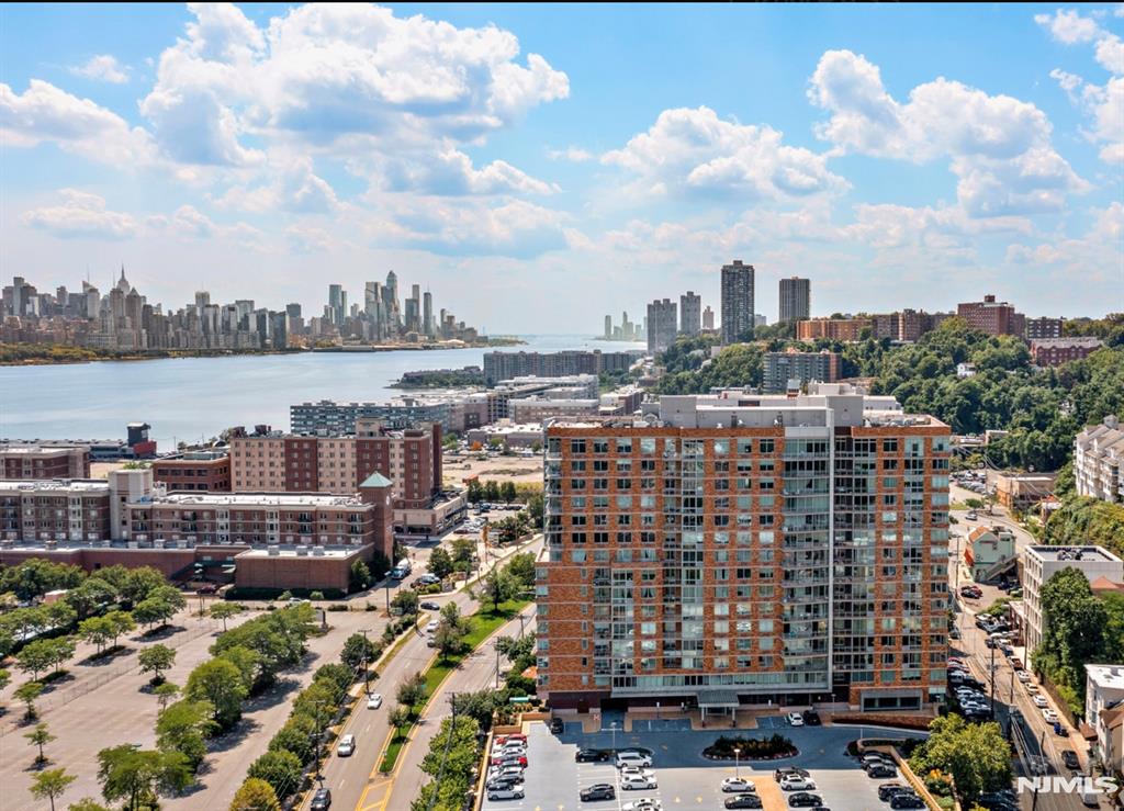This residence comprises a spacious two-bed, two-bath unit with abundant natural light, featuring a granite countertop and stainless-steel appliances. The property offers convenient parking and is considered one of the best spots. The building offers excellent amenities, including a swimming pool, rooftop deck, playroom, and gym. The building is located near an NJ Transit bus, providing easy access to NYC. The bus stop is at the corner of the building, so it takes only 30 seconds to walk there. The lease requires a security deposit equal to 1.5 months' rent, payable at signing. Additionally, a $300 non-refundable building move-in fee, a $300 processing fee, and a $1,000 refundable damage deposit are required. Some of the pictures are virtually staged. *Owner is a licensed real estate agent in the state of NY & NJ.