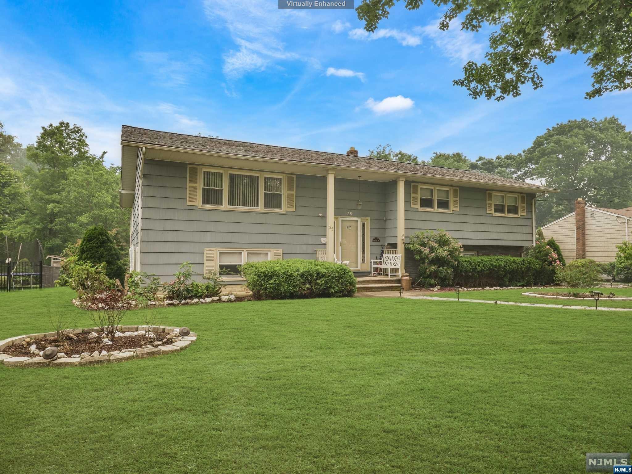 Spacious Bi-Level boasting over 3,500 sq ft, located in formerly known Herfort Heights section of Wayne! Enter into the foyer, which leads up to the living room w/ large window & custom built in shelving & seamlessly flows into the dining room. French doors in dining room lead into the kitchen & family room. The kitchen offers sep dining area & plenty of cabinetry storage! The family room is truly the heart of the home! From the skylights & vaulted ceilings to the numerous windows allowing beautiful natural light in - you'll never want to leave! The primary bedroom is located on the opposite side of the 1st floor featuring en suite w/ storage vanity & stall shower w/ sliding glass enclosure. 3 additional bedrooms & full bath complete 1st floor. Ground floor offers Mother/Daughter fully equipped w/ kitchen, living/family room & dining room. There are also 2 spacious bedrooms w/ large closets & full bath. Backyard offers deck that leads down to large patio area & large, level yard.