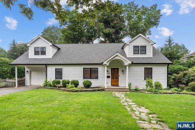 Impeccably renovated colonial on Ridgewood's West Side! Offering the best modern luxury paired with a prime location just a block from Ridge Elementary, the bus and train to NYC, shops, and restaurants. On the first level is an open floor plan featuring a gourmet eat-in kitchen with a trendy oversized center island, Wolf appliances & quartz countertops, overlooking a family room with fireplace, a formal dining room with wet bar, and two convenient 1st-floor bedrooms or home offices/dens that share a stunning full bath. Three bedrooms, 2 full baths, and laundry on the 2nd level, including an expanded primary suite with double walk-in closets and a spa-like bath with cathedral ceilings. Part-finished basement, private backyard with a patio for outdoor entertaining, and attached one-car garage off the mudroom. Enjoy the convenience of being close to everything in this pristine Old Country Club residence!