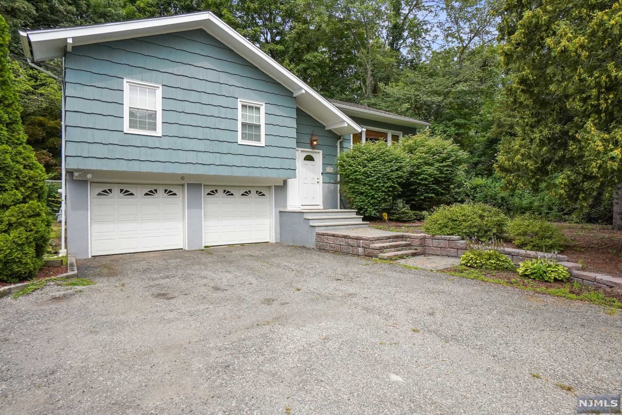 Come and check out this great bi-level home in West Milford, NJ. Close to Greenwood Lk as well as the center of town. The home features a large yard with new fence and storage sheds on the property. Walk in the front door and take the steps up to your large LR w/large windows to let in the sunlight. The DR is right off the kitchen and features sliders out to your back yard deck. 3BR's and a lovely full BA round out the upstairs. MBR also features a half BA. Go downstairs and there is an entrance to your 2 car garage so you don't have to go outside to get in your home. There is also a utility room and oversized FR which is great for entertaining. Sit on your deck and enjoy the private back yard with woods all around. This is a great home that is just looking for a new owner. Get in b4 its too late!!!!