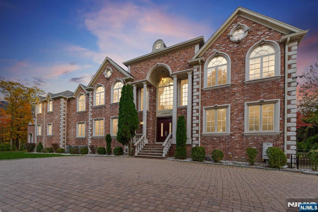 Set on over 4+ private acres in a dreamlike cul-de-sac setting within the prestigious Rio Vista section of Alpine, this exceptional brick estate offers more than 10,000 square feet of refined living space across all levels, thoughtfully designed for both grand-scale entertaining and everyday luxury. The home features 2 expansive primary suites, one on each level, 3 fireplaces, and a private elevator. The top-floor entertainment level includes a sophisticated lounge and full bath, creating a perfect retreat for hosting or relaxation. The finished lower level is equally impressive, offering a private home theater, recreation room with bar, gym, full bath, additional half bath, and French doors that open directly to a serene backyard oasis. Gorgeous natural light, the residence showcases soaring ceilings, an elegant layout, and beautifully proportioned living spaces throughout. A 4 car garage caters to the ultimate car enthusiast. Meticulously maintained and in absolute move-in condition, this extraordinary property presents a rare opportunity to enjoy estate living in one of Alpineâ€™s most coveted enclaves.
