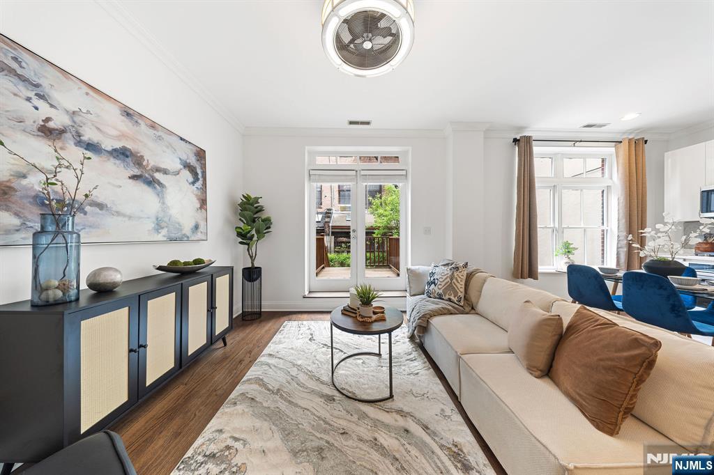 Welcome to 104 York Street, an exceptional boutique residence situated in the highly sought-after Paulus Hook neighborhood of Jersey City. This rare offering features two bedrooms, two bathrooms, and a beautifully designed private backyard patio. The open-concept living and dining area flows seamlessly to a spacious deck that leads to a serene backyard oasis with pavers, professional landscaping, elegant lighting, and full fencing, perfect for relaxing or entertaining. The top floor showcases a renovated chefâ€™s kitchen equipped with new KitchenAid appliances, complemented by gleaming hardwood floors that extend throughout the home. The lower level includes two generously sized bedrooms, one with direct access to the tranquil yard, while the primary suite features a fully renovated bathroom with a sleek vanity, modern fixtures, and updated lighting. Additional highlights include freshly painted interiors, crown molding, a full guest bathroom, and the convenience of an in-unit washer and dryer. Ideally located within the desirable PS16 school district and near top private schools, this home offers unparalleled access to transportation, including Exchange Place PATH, Grove Street PATH, and the Manhattan ferry. Enjoy proximity to Jersey Cityâ€™s finest restaurants, Whole Foods, parks, boutique shops, and vibrant nightlife. Combining luxury, comfort, and an unbeatable location, this property is truly move-in ready and not to be missed.
