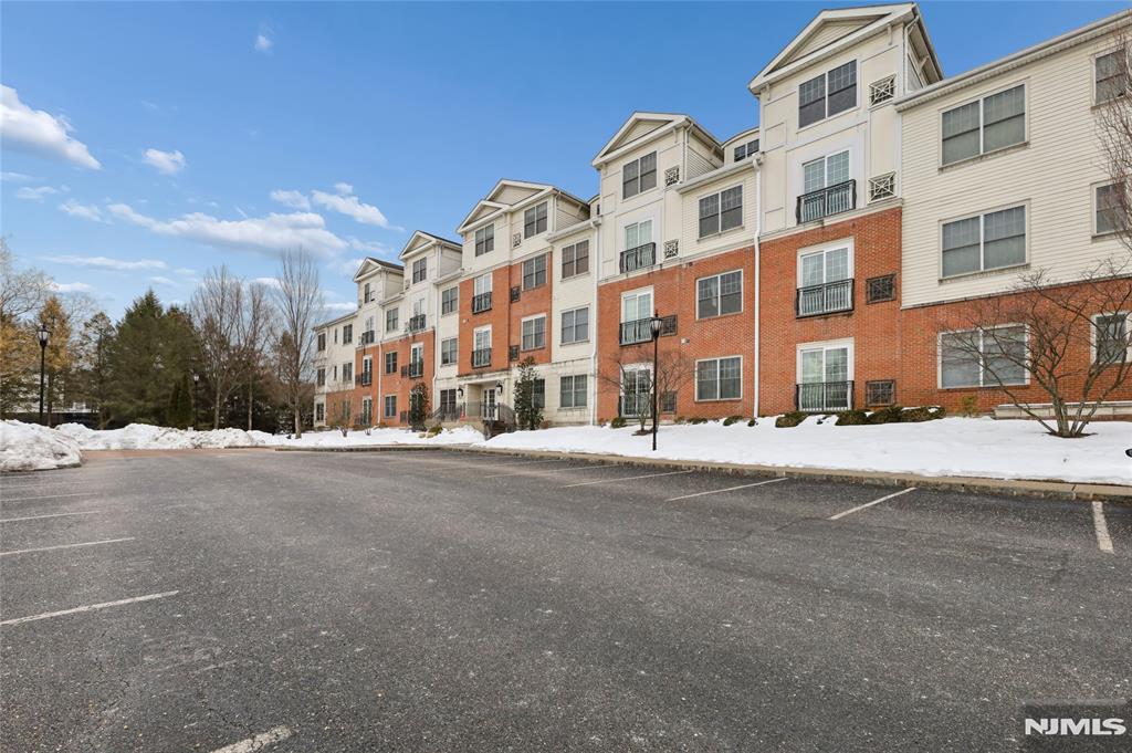 Welcome to The Plaza at Tenafly, a prestigious gated community offering luxury living just minutes from Manhattan. This elegant residence features beautiful hardwood floors throughout the entry foyer, living room, and dining room, along with dramatic 10-foot ceilings and oversized Pella windows that fill the home with natural light. The gourmet kitchen is thoughtfully designed with 42" custom cabinetry, granite countertops, a Viking range, Sub-Zero refrigerator, dishwasher, and microwave, plus a convenient dining area and in-unit laundry. The spacious living room provides an inviting setting for everyday living and entertaining. The primary bedroom suite includes a full bath, complemented by a second bedroom and an additional full hallway bathroom. Residents enjoy exceptional amenities including a full-service concierge, outdoor heated pool, entertainment room with billiards, state-of-the-art fitness center, media room with high-quality sound and video system, and a picturesque gazebo surrounded by lush landscaping. This home includes two reserved parking spacesâ€”one indoor and one outdoorâ€”with parking included in the monthly maintenance. Ideally located near transportation, shopping, and Tenaflyâ€™s highly regarded Blue Ribbon school district. Pet-friendly community. An exceptional opportunity to enjoy luxury, convenience, and comfort at The Plaza at Tenafly.