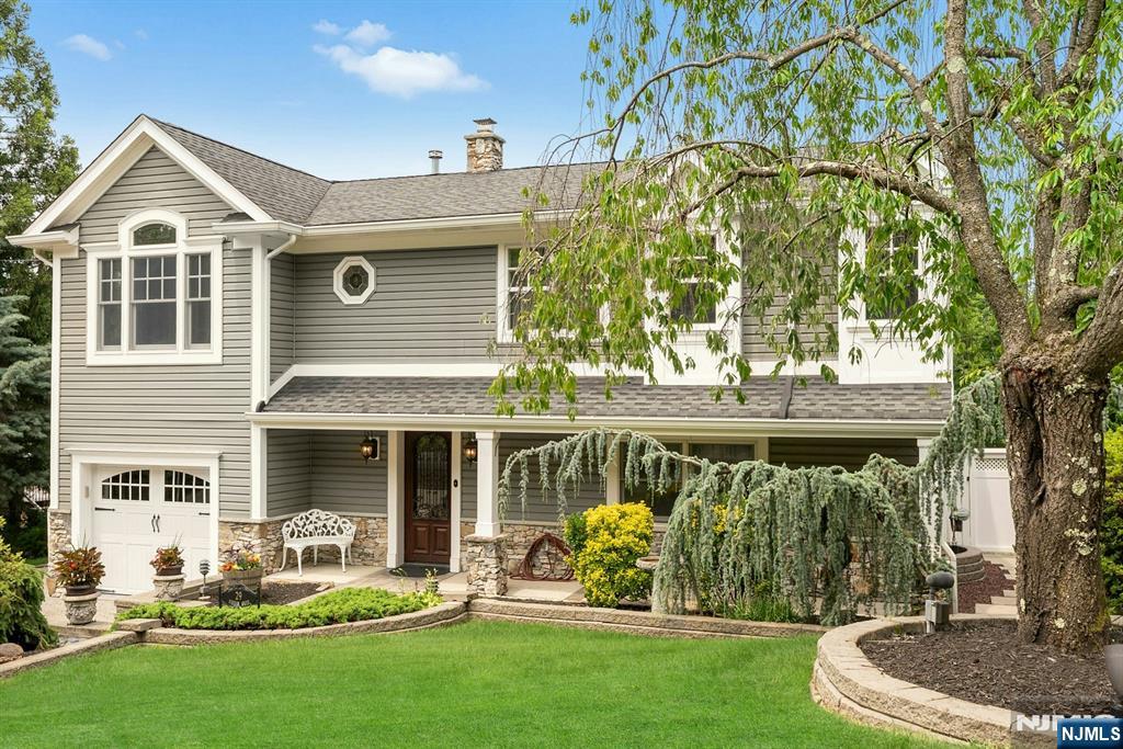 Welcome to this spacious 3-bedroom, 3-bath raised ranch located in a charming Wanaque neighborhood known for its great schools and community feel. This unique home offers a flexible floor plan perfect for today's needs including a full in-law suite on the first floor with its own full kitchen, bedroom, living space and paver patio. The main level features an inviting living room with high ceilings, a cozy gas fireplace and oversized windows that fill the space with natural light. There's a massive eat-in kitchen with all the amenities including a huge island with wine fridge. The open floor plan includes sliders leading to a deck ideal for entertaining or simply enjoying lovely views of the surrounding area. The main level also features a separate dining room which could also be converted to a bedroom, another bedroom with walk in closet and the primary suite. The owner's suite features a large updated bathroom and closet with room to spare. This home combines comfort, versatility, and location all within easy reach of shopping, parks, and major roadways. Don't miss the opportunity to make it yours!