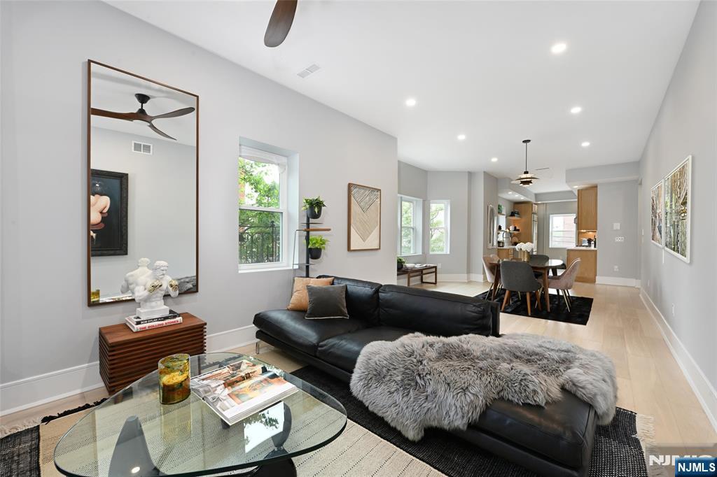 This impeccably renovated 3-bedroom condo sits on one of Hobokenâ€™s most desirable corners, directly across from Stevens Institute and Park. Flooded with natural light, this corner home features a stunning chefâ€™s kitchen with custom solid oak cabinetry, floating shelves, quartz countertops, and premium appliances: a 36â€ Thermador refrigerator, Viking Pro 5-burner cooktop, wall oven, dishwasher, and microwave drawer. The open-concept layout offers an expansive living and dining area, enhanced by 8â€ white oak rift-and-quartered hardwood floors and oversized, energy-efficient soundproof windows. Three well-appointed bedrooms provide ideal privacy, including a spacious primary suite with a luxurious en-suite bath featuring Italian terrazzo tile, a designer vanity, Grohe fixtures, and a frameless glass walk-in shower with a linear French drain. The adjoining walk-in closet offers flexible use as a nursery or dressing room. Additional highlights include an elegant second bath, 8-foot solid core doors, abundant storage, a full-size slim line IQ washer/dryer, Alexa-enabled smart switches, a Level smart lock, and dual-zone mini-split HVAC for custom comfort. Perfectly situated near the waterfront, Washington Street, NYC transit, and Hobokenâ€™s best dining and shops. Parking available nearby for an additional fee.