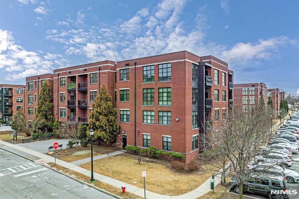 Welcome home to The M at Englewood South. This beautifully maintained 1,410 sf large corner-unit condo offers 2 bedrooms, a versatile den, and 2.5 bathrooms, featuring an open floor plan and high ceilings that create a comfortable, inviting atmosphere. The modern kitchen features granite countertops, quality appliances, and a breakfast bar overlooking the living and dining areas. Both bedrooms offer walk-in closets and private en-suite bathrooms. The spacious primary suite includes dual vanities and a separate shower, while the second en-suite bath features a tub and a single vanity. Enjoy the convenience of 2 deeded garage parking spaces, a beautifully maintained outdoor pool, club room, pet-friendly living with nearby walking areas for dogs, a secure professionally managed building, and included cable and internet. Ideally located just minutes from the George Washington Bridge with easy access to New York City, and close to shopping, dining, and parks. Move right in and enjoy all that The M has to offer!