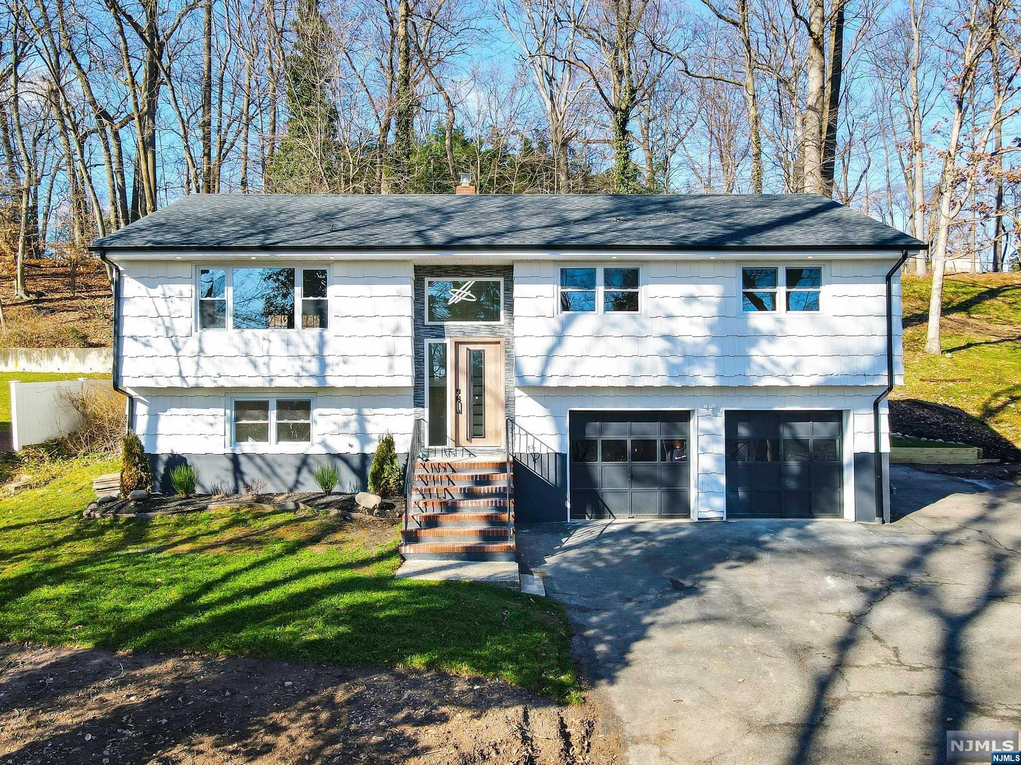 WELCOME TO YOUR DREAM HOME! ESCAPE TO TRANQUILITY AS YOU ENTER THE WINDING DRIVEWAY FOR ULTIMATE PRIVACY ON THIS 1/2 ACRE LOT. THIS SECLUDED BI-LEVEL HOME, WITH STUNNING VIEWS, IS COMPLETELY RENOVATED WITH A GORGEOUS, GOURMET KITCHEN, CENTER ISLAND, QUARTZ CTRS, POT FILLER AND NEW SS APPL(A CHEF'S DELIGHT) THE OPEN CONCEPT DESIGN SEAMLESSLY CONNECTS THE KIT. TO THE DR AND WELCOMING LR, W/FRENCH DOORS TO DECK, PERFECT FOR ENTERTAINING! YOU WILL STEP INTO LUXURY WITH THIS 5 BEDROOM, 2.5 BATHROOM HAVEN THAT BLENDS MODERN SOPHISTICATION W/FAMILY FRIENDLY FUNCTIONALITY AND STUNNING DESIGN. IT IS AN IDEAL LAYOUT FOR EXT.FAMILY OR HOSTING GUESTS. THE BATHROOMS, ADORNED WITH EXQUISITE TILE WORK AND LAVISH SHOWER STALLS, ELEVATE THE HOME! FEAT: 2 ZONE GAS HWBB HEAT, C/A, ALL NEW WINDOWS AND NEW ROOF. SAVOR THE SERENE SETTING W/PAVER PATIO NESTLED IN THE WOODS YET MINUTES FROM DOWNTOWN. PRIVATE SHARED ROAD TO DRVWY W/NEIGHBOR. ENJOY THE SECULSION OF THIS MOUNTAIN RETREAT. CLOSE TO NYC TRANS