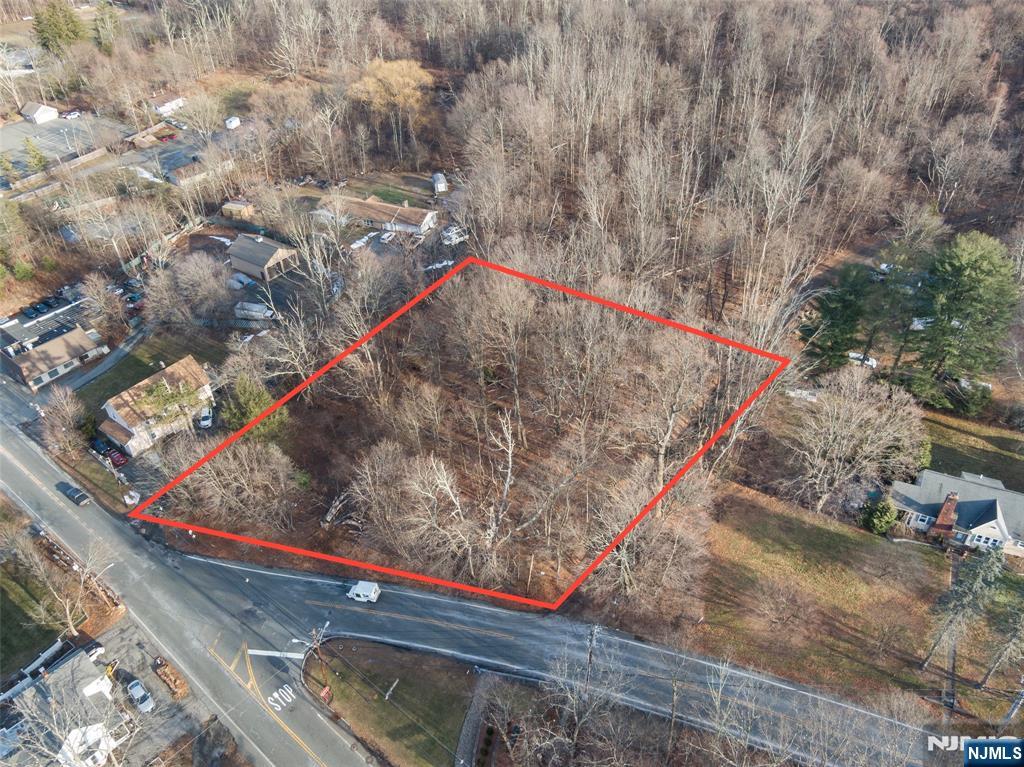 2046 Macopin Road, West Milford, NJ presents a rare opportunity to develop in a high-visibility, mixed-use corridor with excellent accessibility. This fairly level, wooded lot is ideally situated at the junction of Macopin Road and Union Valley Road, with additional frontage along Mickens Road, offering strong exposure from multiple directions. The property is zoned OT - Transitional Residential/Commercial, allowing for a wide range of permitted uses including professional offices, medical or dental offices, daycare/childcare facilities, personal services, and other neighborhood-compatible commercial or residential uses (full list of permitted uses available upon request).The lot gradually slopes upward from the road to a more level building area, providing flexibility for site planning and development. Its strategic location offers easy access to Route 23, making it convenient for commuters, clients, and local traffic alike. Tank sweep and perc test results are available upon request and are provided for informational purposes only. Buyers are encouraged to perform their own due diligence with the Township of West Milford regarding intended use and development requirements. An excellent opportunity for investors, developers, or owner-users seeking a versatile property in a well-traveled North Jersey location.
