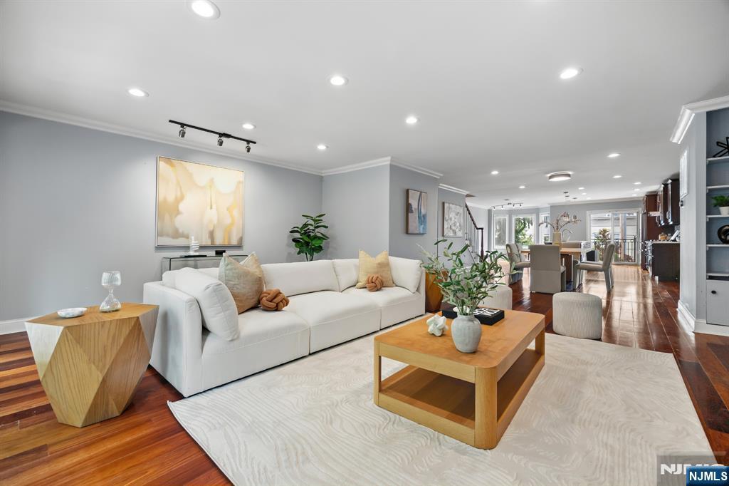 This spacious, move-in-ready townhouse offers 4 bedrooms and 3 full bathrooms, combining exceptional layout, quality finishes, and everyday convenience, nestled in the peaceful neighborhood of Cliffside Park, just minutes from shopping, dining, parks, and convenient transportation to New York City. The ground level features a private living suite with a full bathroom, making it ideal for guests, extended family, or a home office.The second floor boasts an open-concept layout designed for comfortable living and entertaining. The bright and inviting living and dining areas flow seamlessly into the modern kitchen, complete with circulating range hood and finishes.The third floor is highlighted by a luxurious primary suite featuring a cozy fireplace, a private terrace with breathtaking New York City skyline views, a spacious walk-in closet, and a spa-inspired en-suite bathroom. Two additional generously sized bedrooms share a well-appointed full bathroom, while a conveniently located laundry area completes the upper level. Additional features include an oversized two-car garage with abundant storage space, making this exceptional home as practical as it is elegant.
